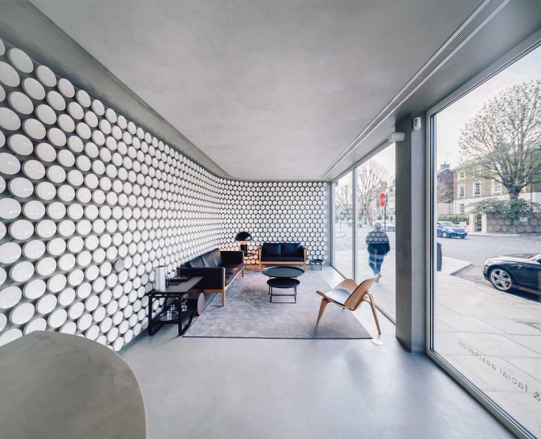 Over 500 Ceramic Disks Cover The Walls To Create A Unique Identity For This Dental Clinic