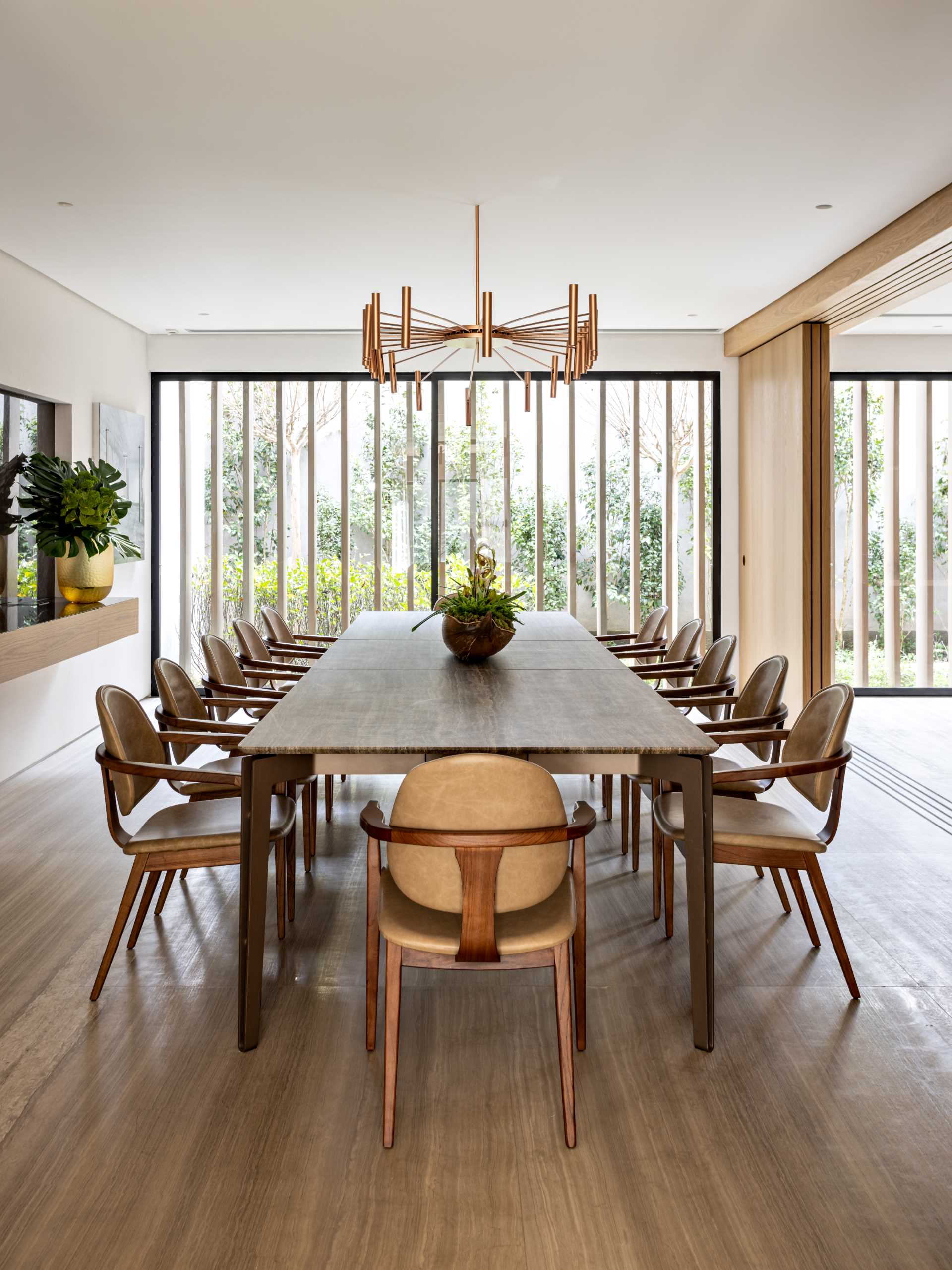 A formal dining room with a large dining table, and a floating sideboard.