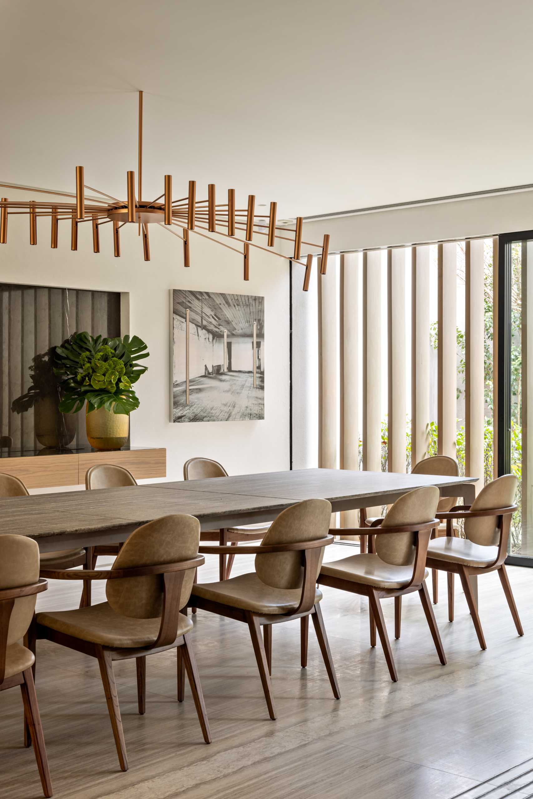 A formal dining room with a large dining table, and a floating sideboard.