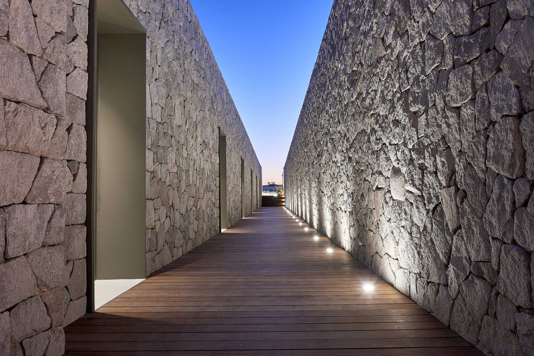Cool gray stone walls are featured throughout this boutique hotel and were exclusively made using local raw materials