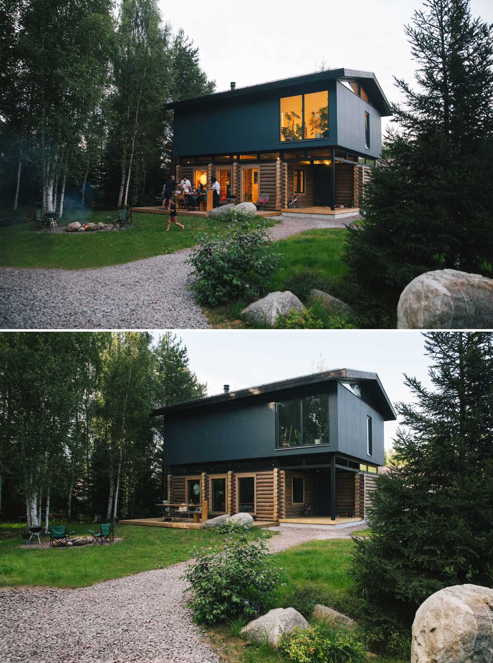 A log home topped with a modern black upper floor.