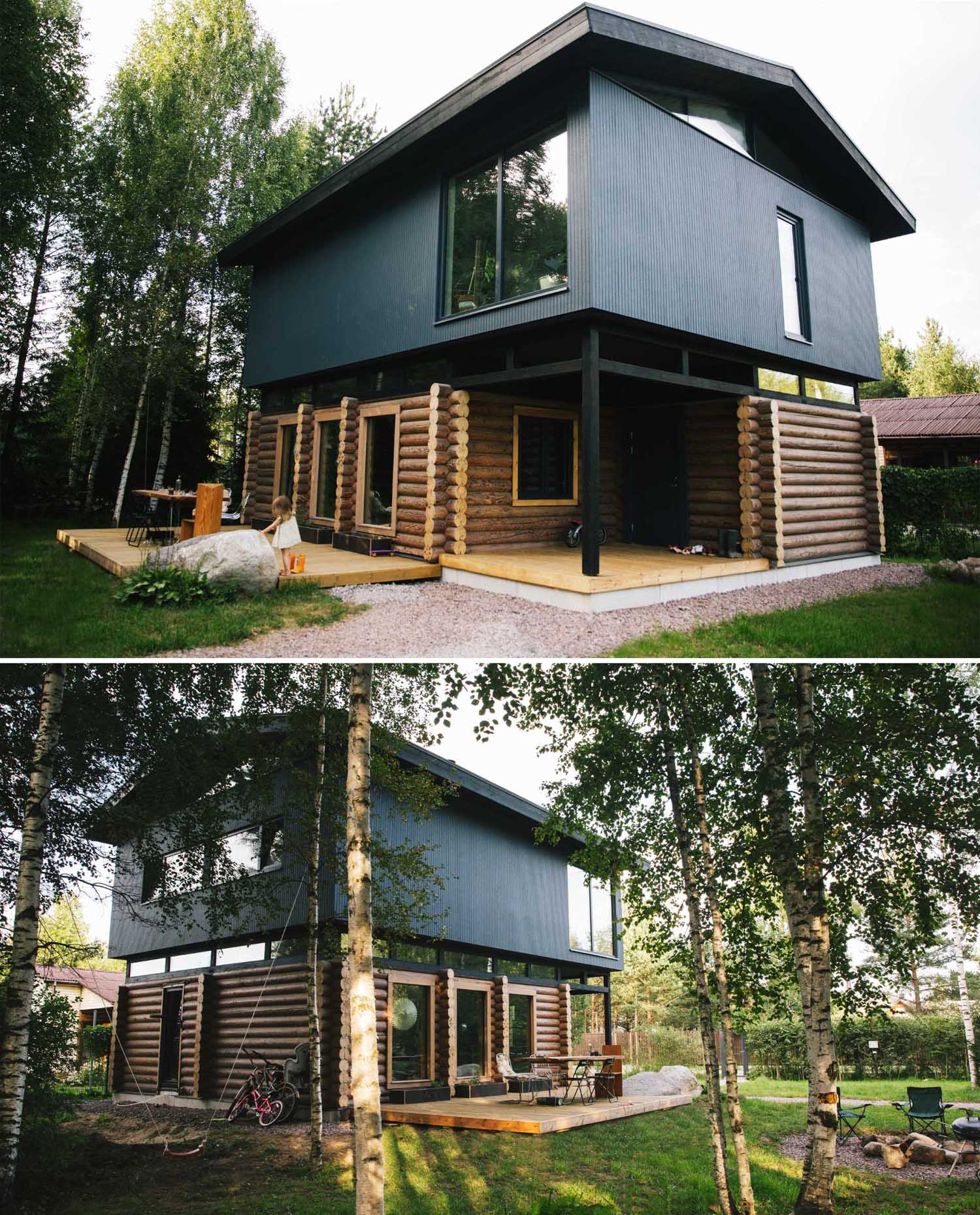 A log home topped with a modern black upper floor.