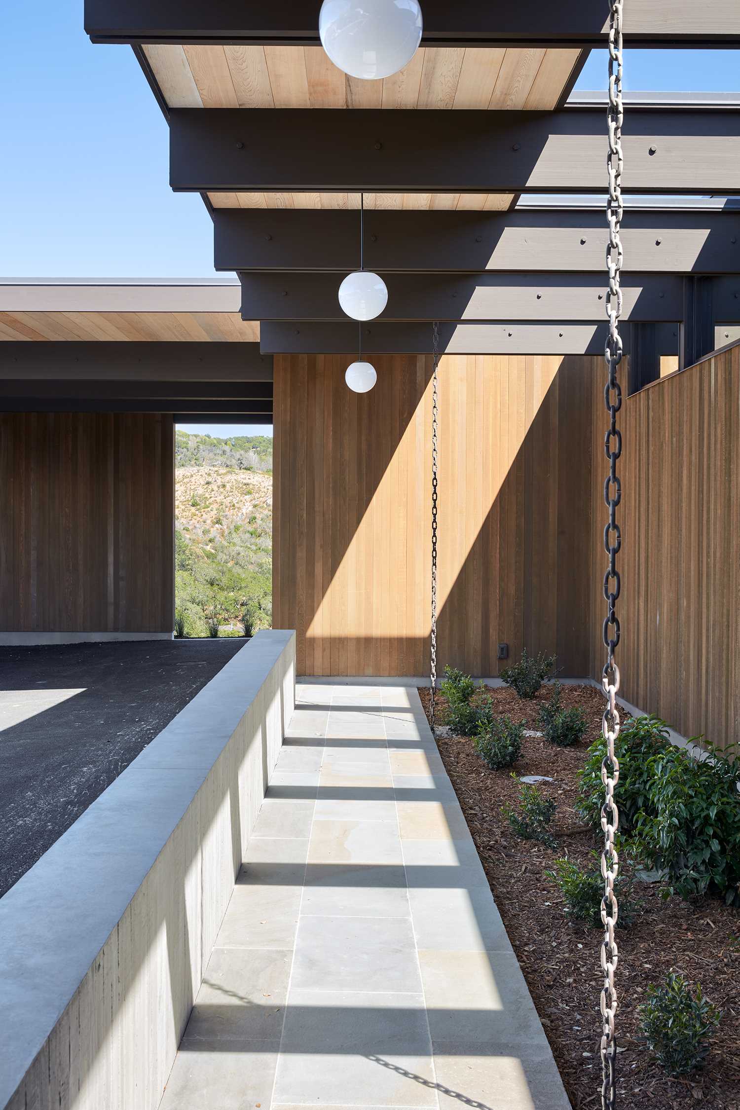 A mid-century modern inspired house includes rain chains in its design.