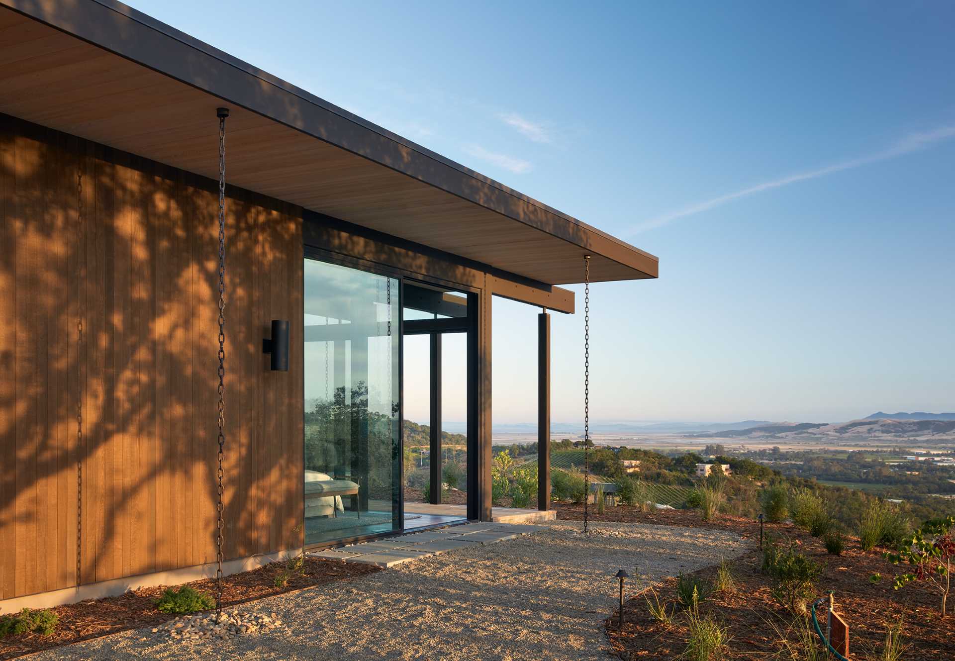 A mid-century modern inspired house includes rain chains in its design.