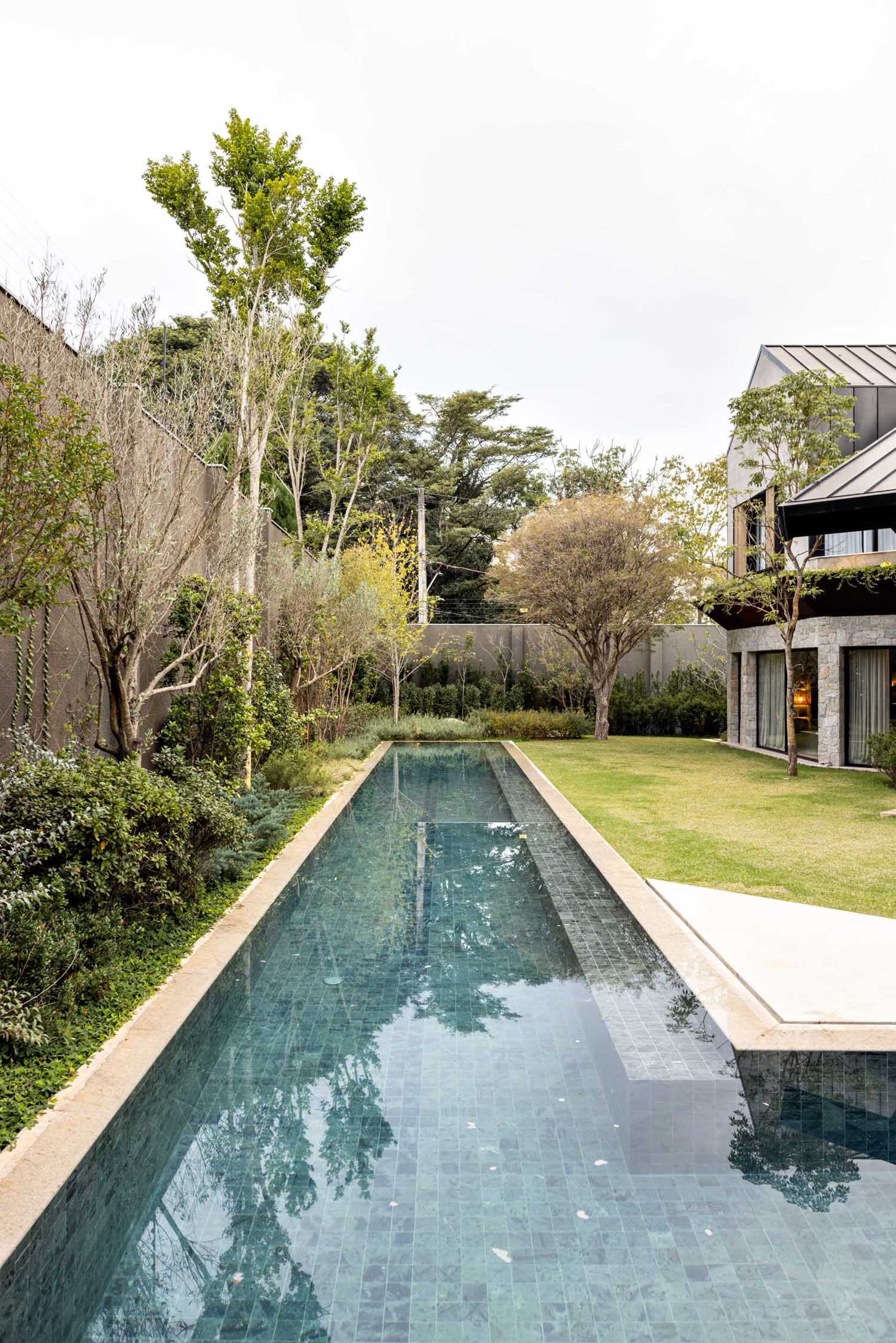 A modern house with a long swimming pool.