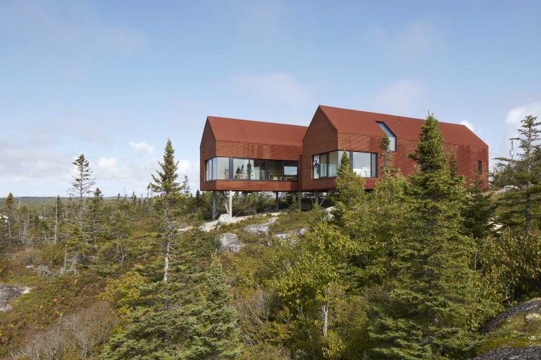 Rusty Corrugated Steel Covers The Exterior Of This Home On The Edge Of A Forested Hillside