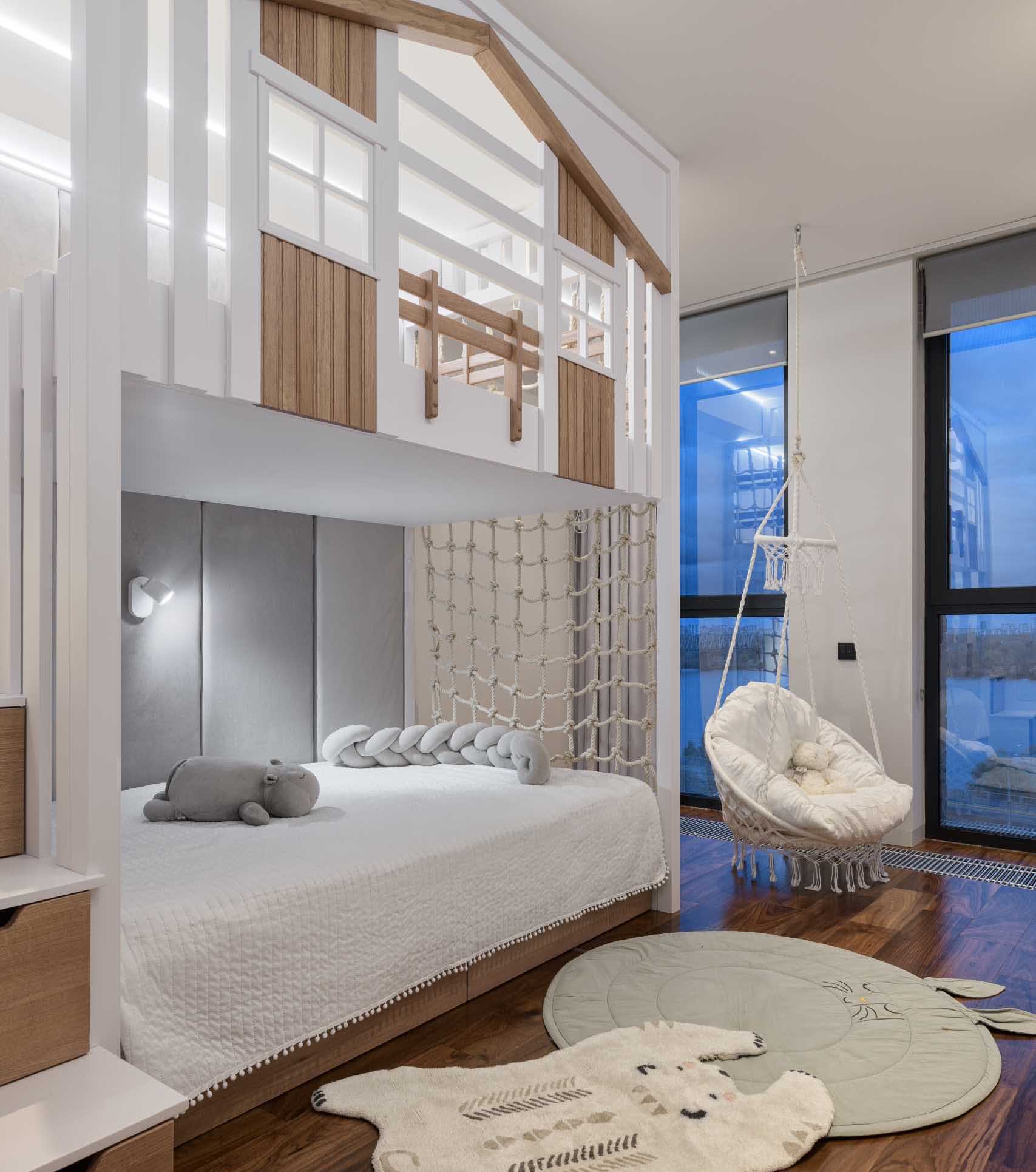 This modern kids bedroom has been designed with a double-story bed, the lower dedicated to the sleeping section, while the upper is a play area.