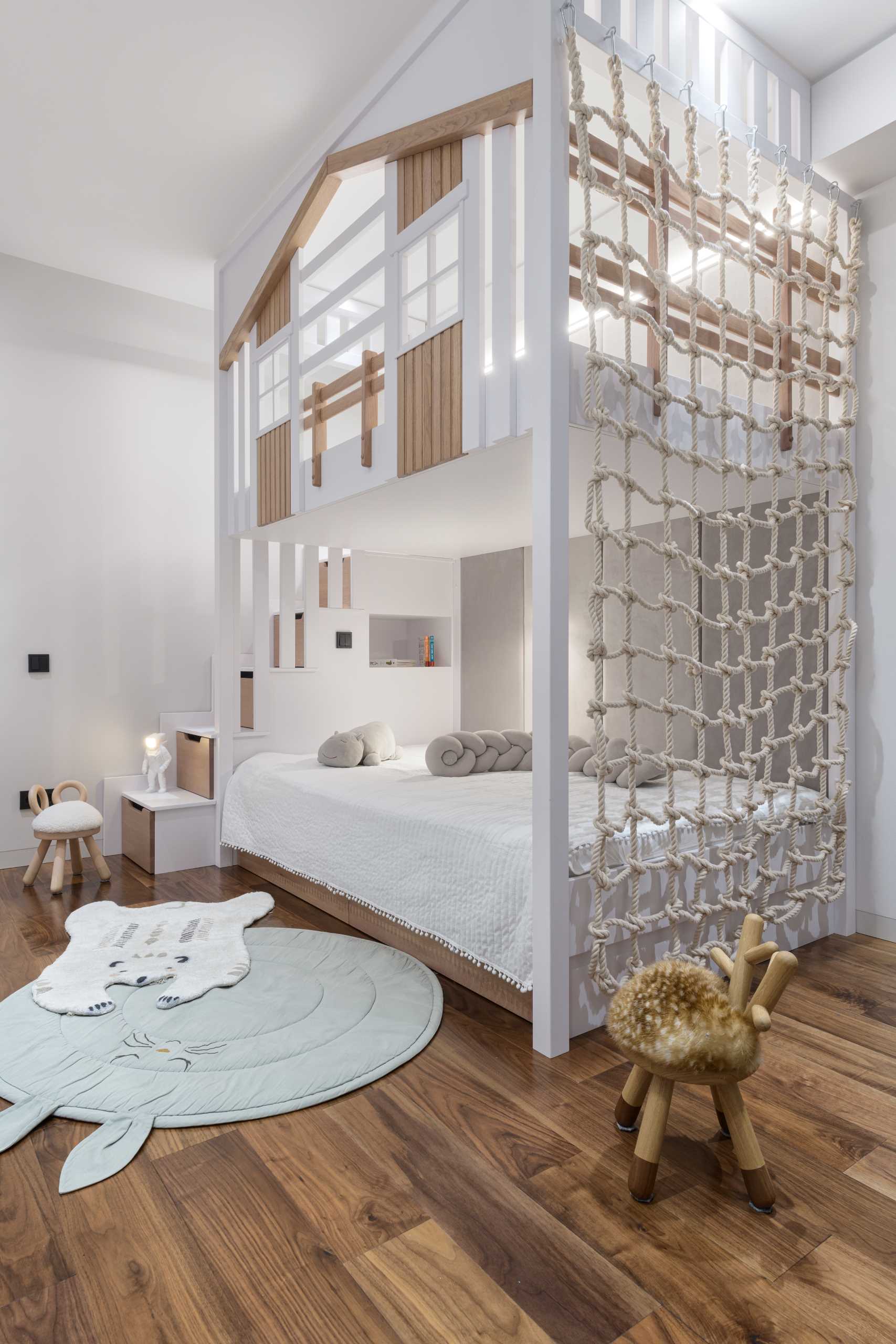 This modern kids bedroom has been designed with a double-story bed, the lower dedicated to the sleeping section, while the upper is a play area.