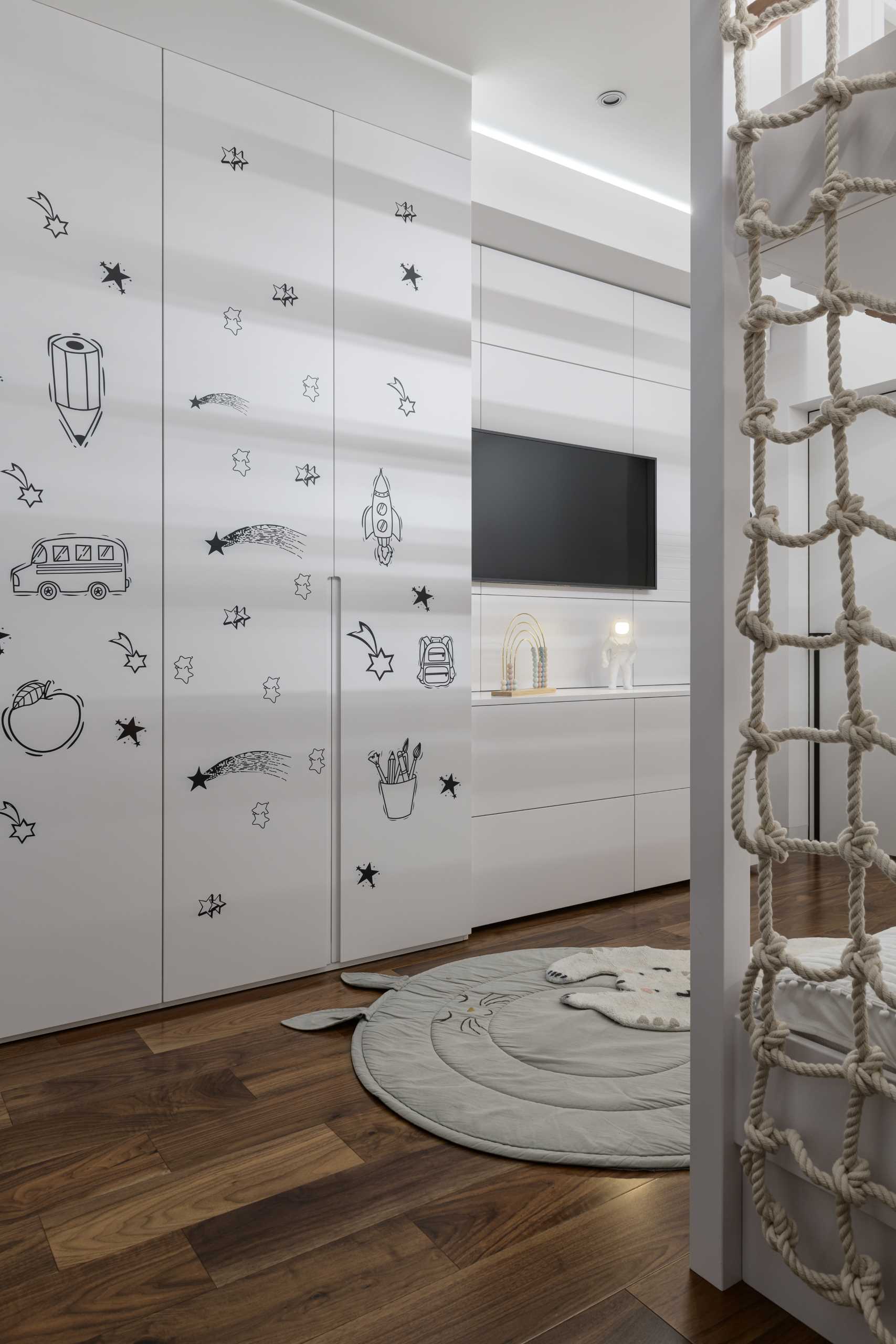 Simple line drawings add a fun decorative element to this modern kids bedroom.