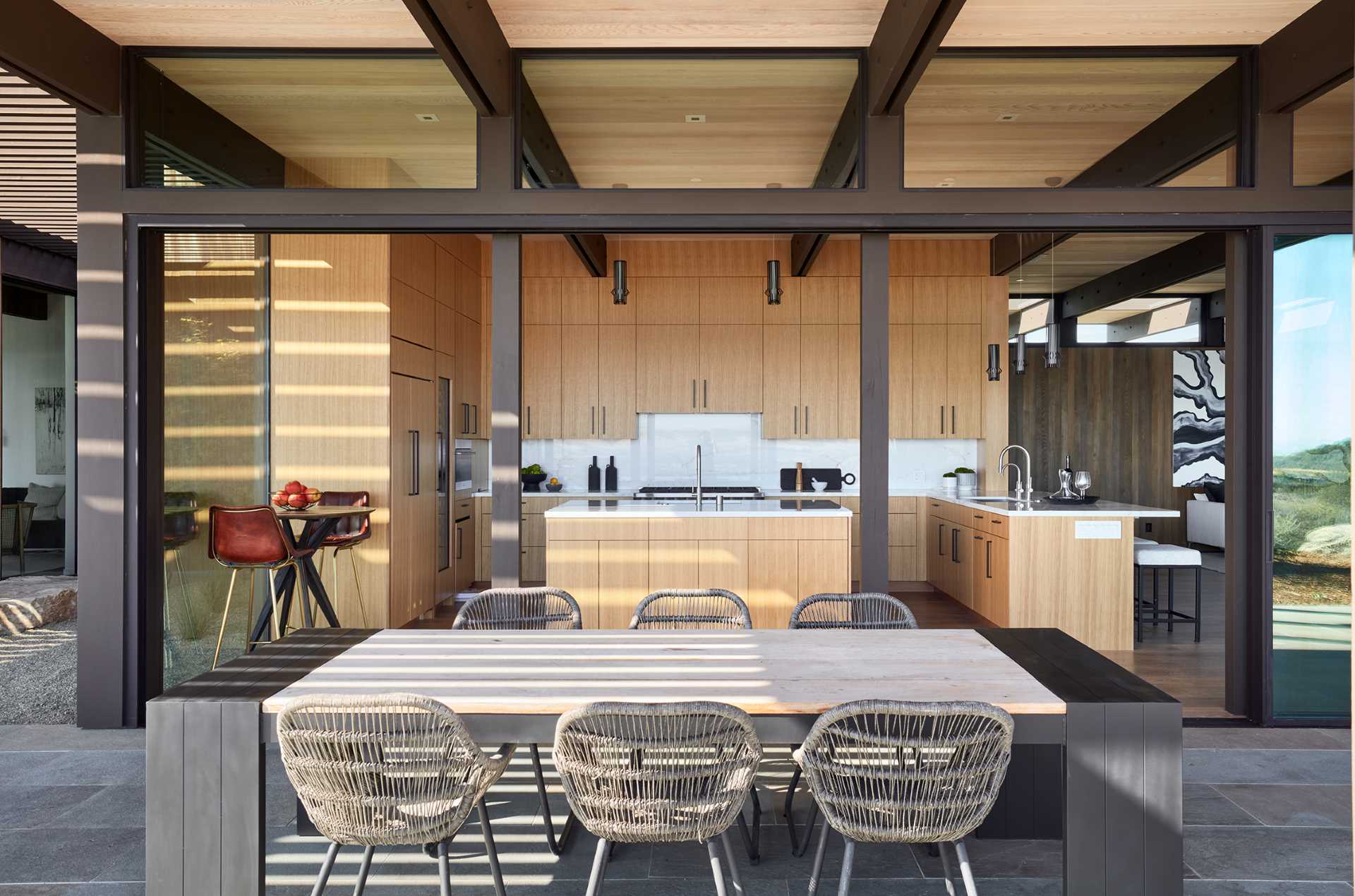 A modern wood kitchen with white countertops.