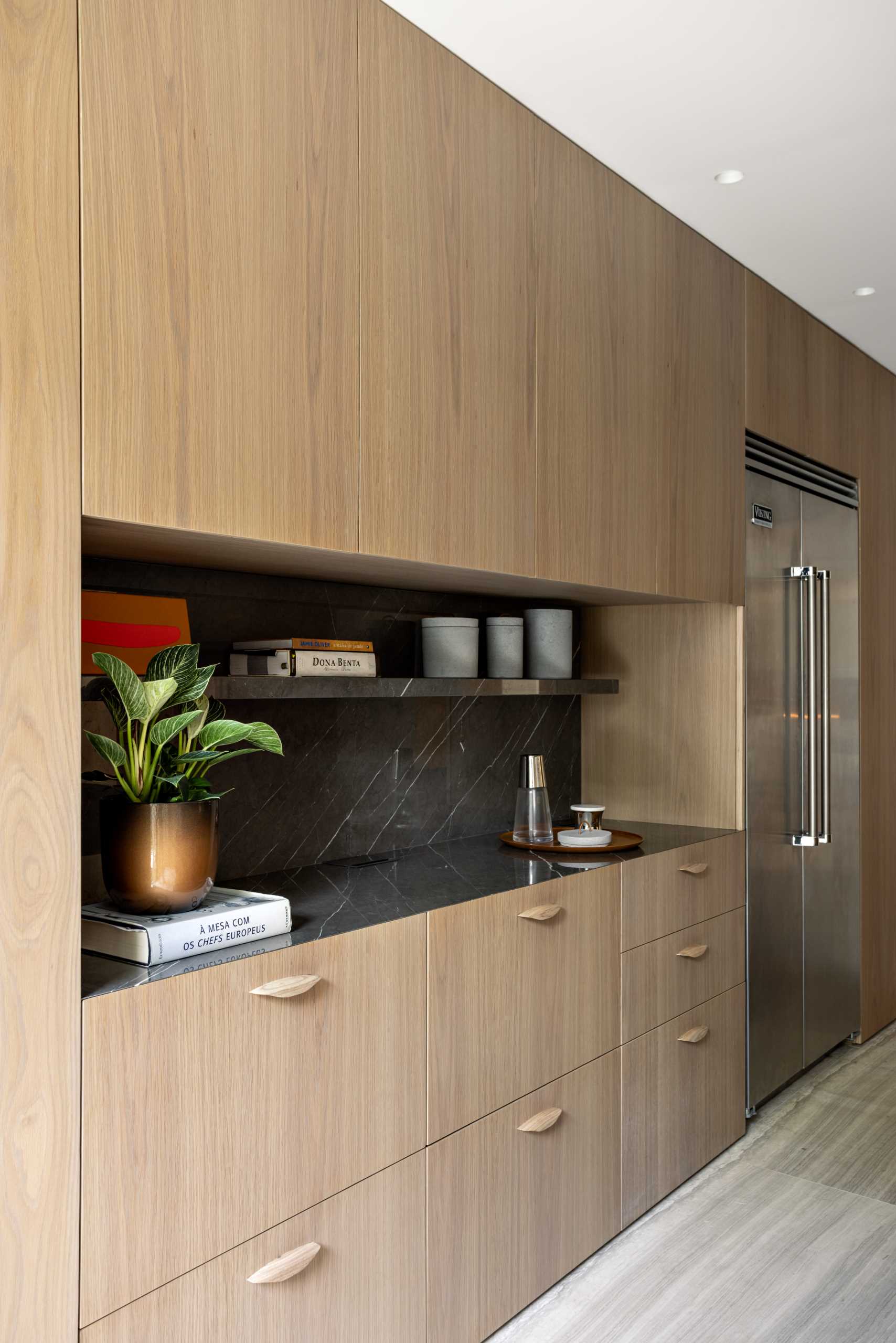 A modern kitchen with wood cabinets.