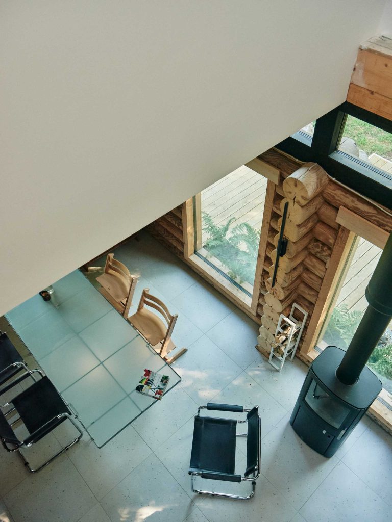 A Pile Of Logs From An Old House Were Used To Create The Bottom Half Of ...