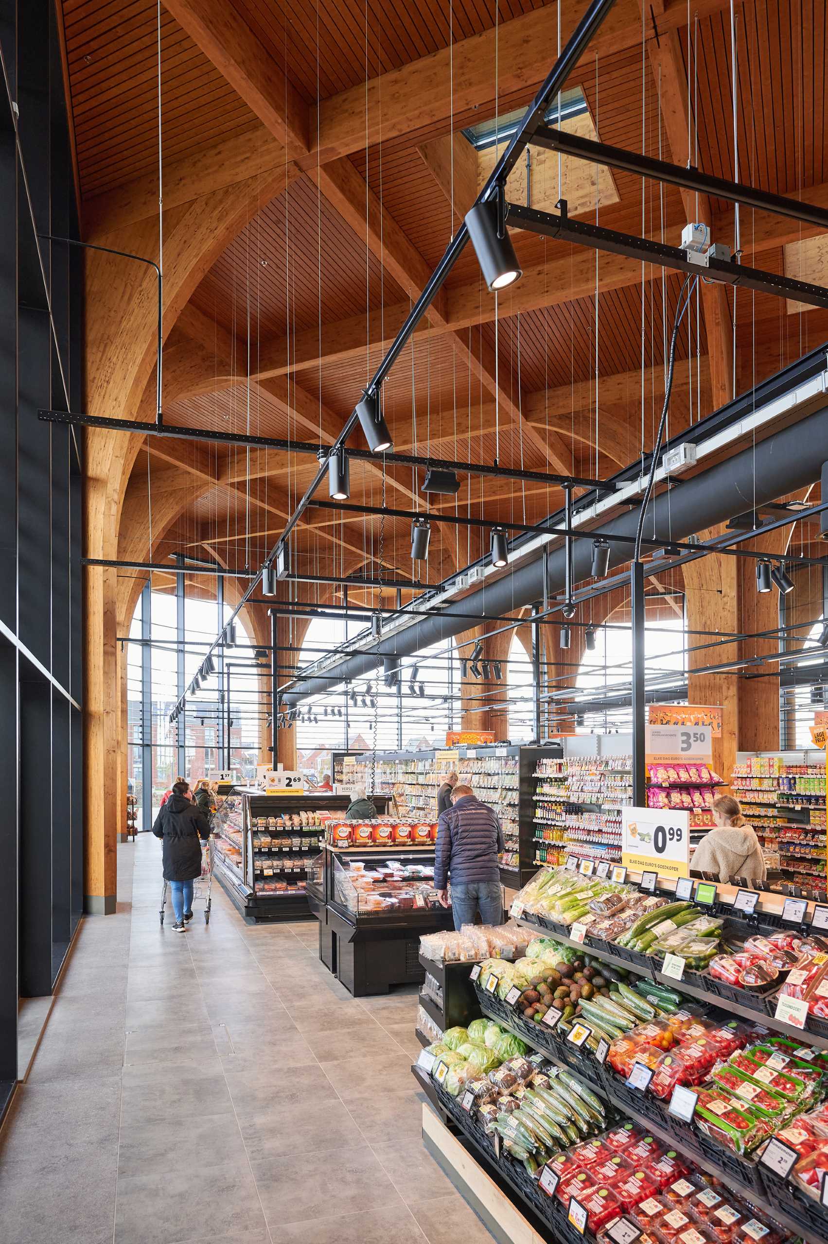 A modern supermarket with an exposed wood structure with a cathedral-like appearance.