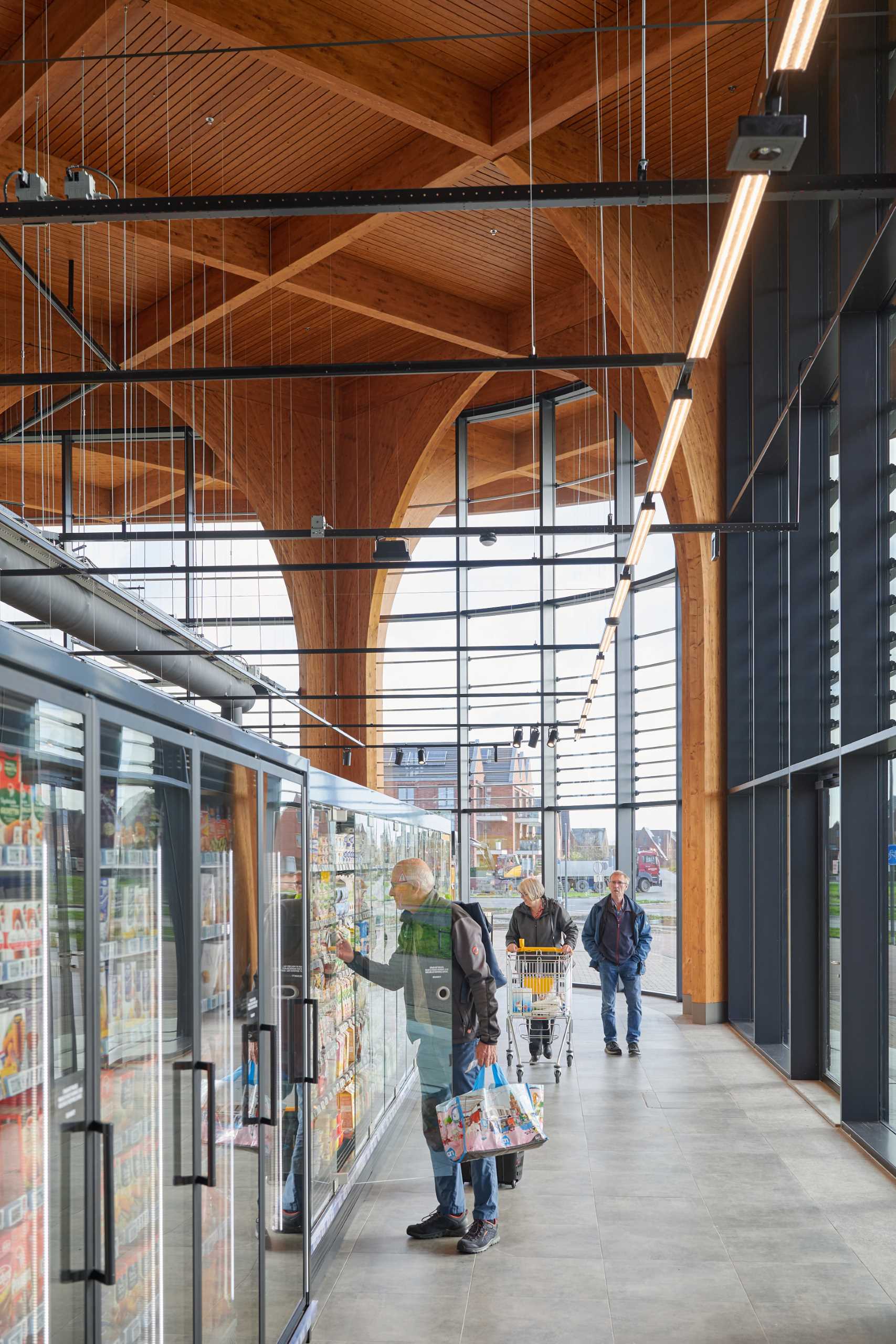 A modern supermarket with an exposed wood structure with a cathedral-like appearance.