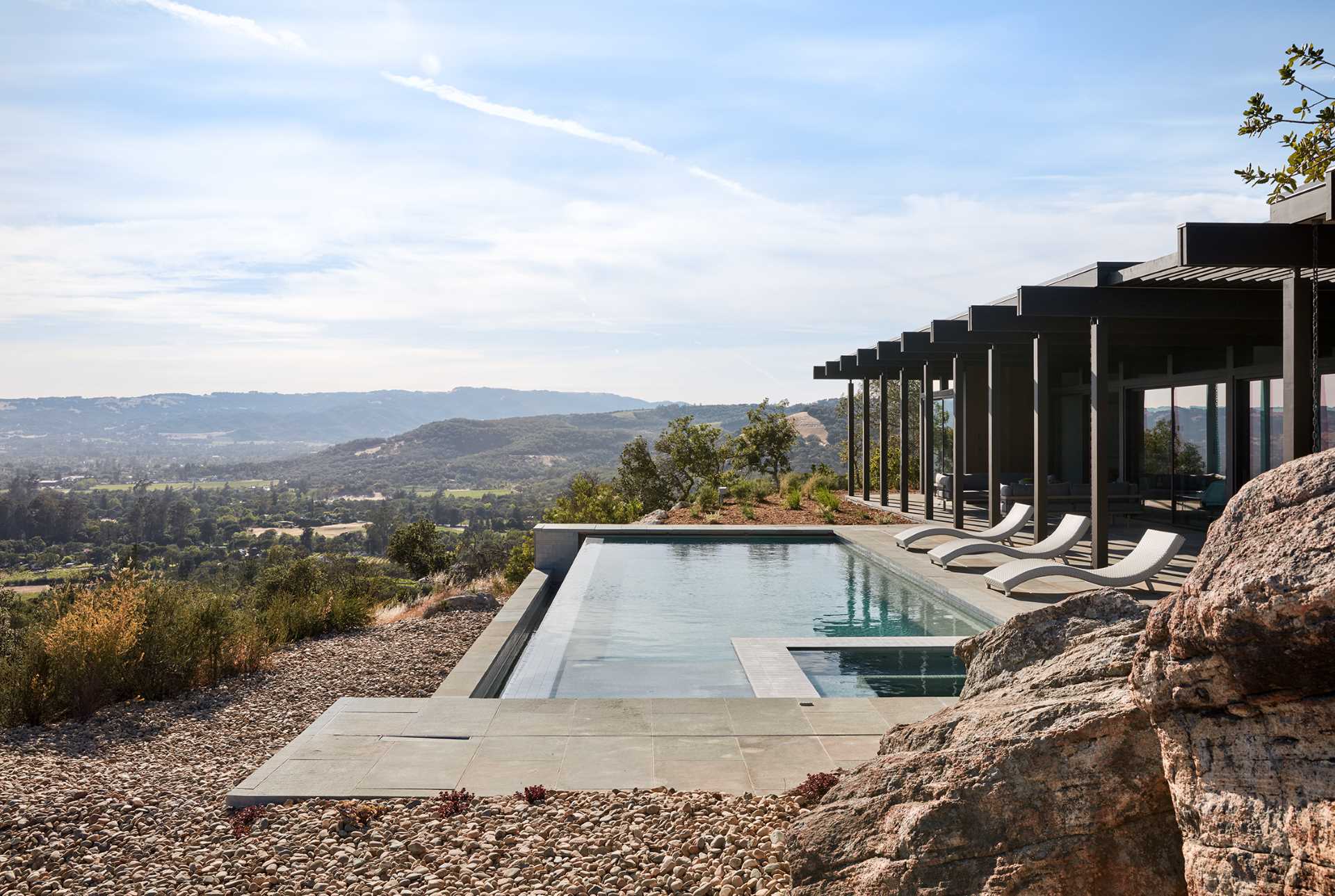 A mid-century modern inspired house design with an infinity-edge swimming pool.