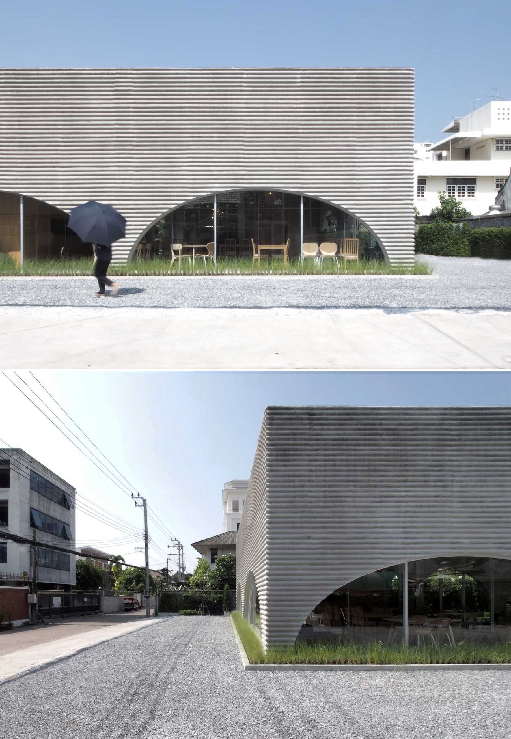 A modern restaurant and cafe with a wavy pre-case concrete facade and arched openings.