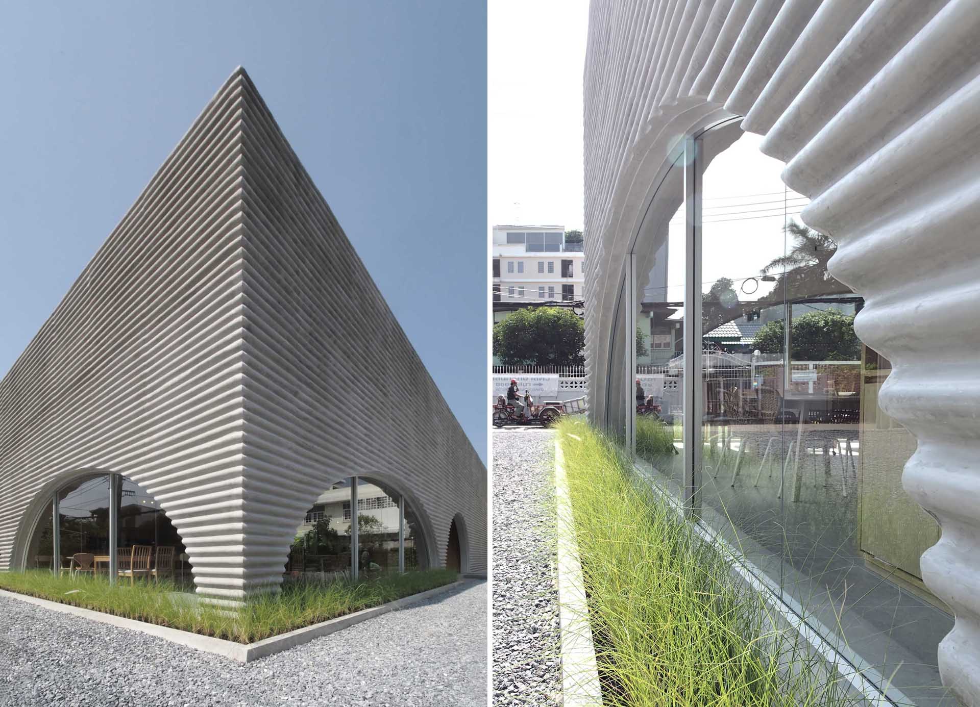 A modern restaurant and cafe with a wavy pre-case concrete facade and arched openings.