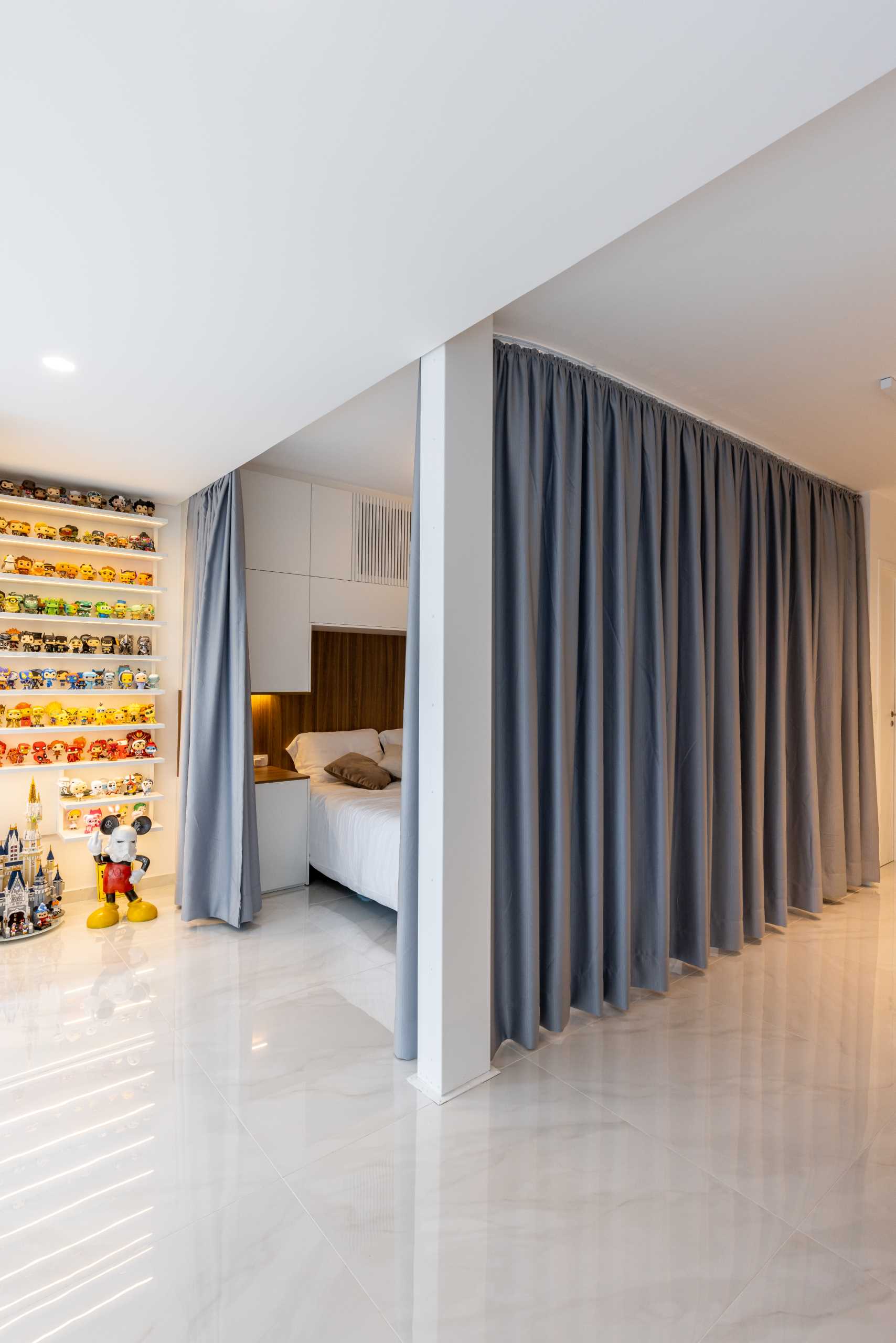 A modern open-plan bedroom with curtains for walls.