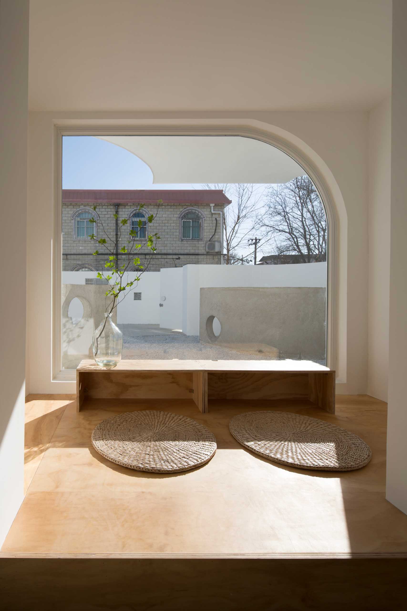 A small sitting area by the front window that provides a view of the courtyard.