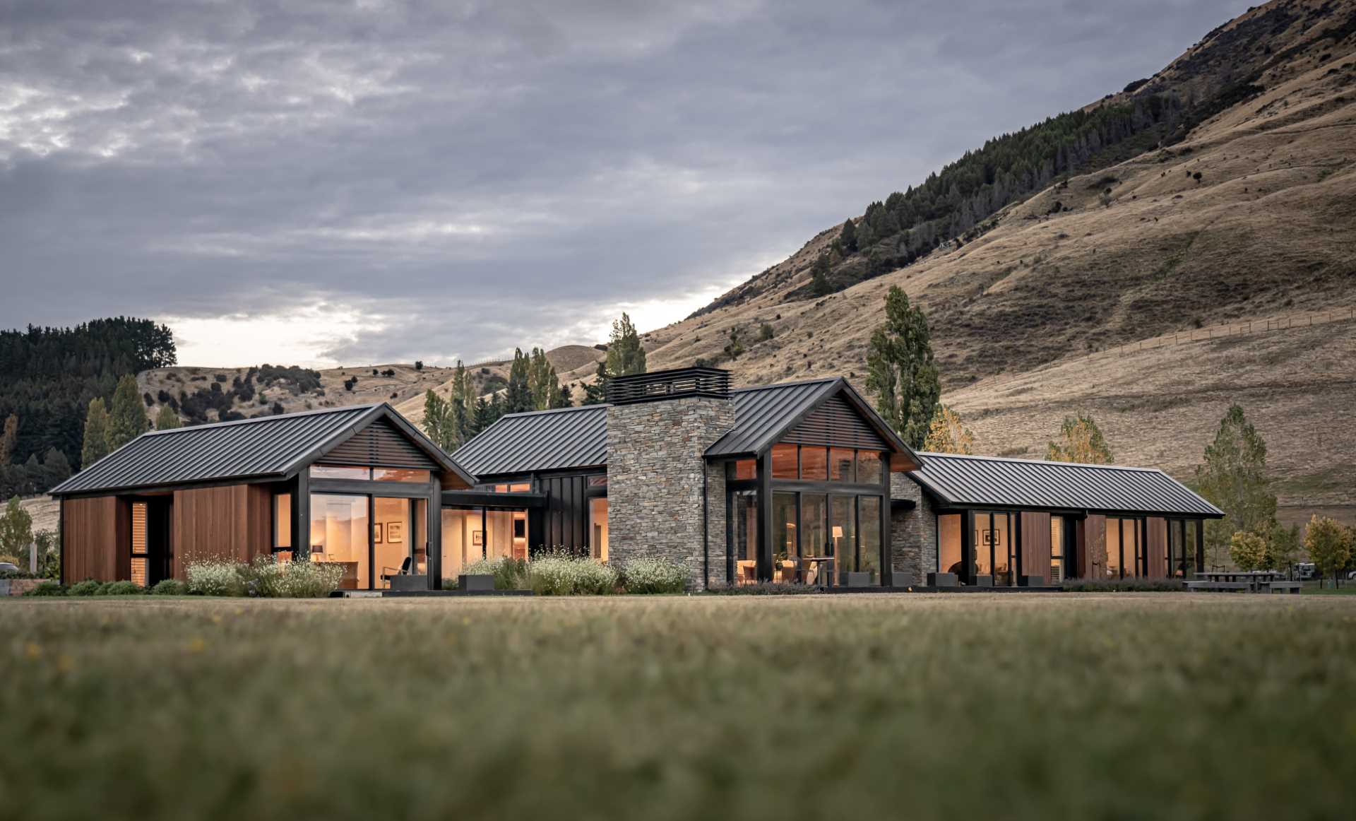 This modern house uses cedar in the build to add warmth, while metal was chosen as a low-maintenance contrasting material, and stone accents were added using Schist.