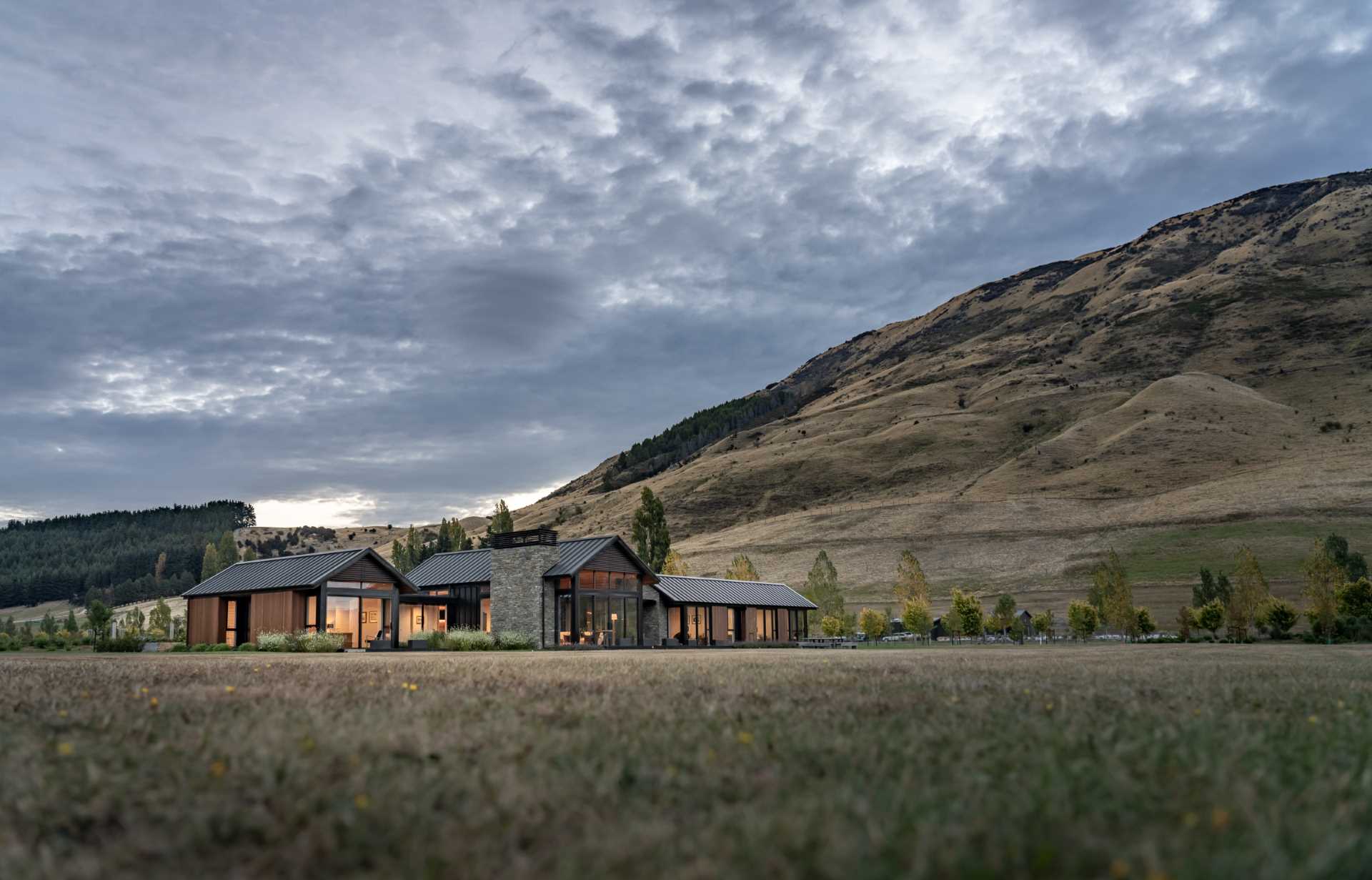 This modern house uses cedar in the build to add warmth, while metal was chosen as a low-maintenance contrasting material, and stone accents were added using Schist.