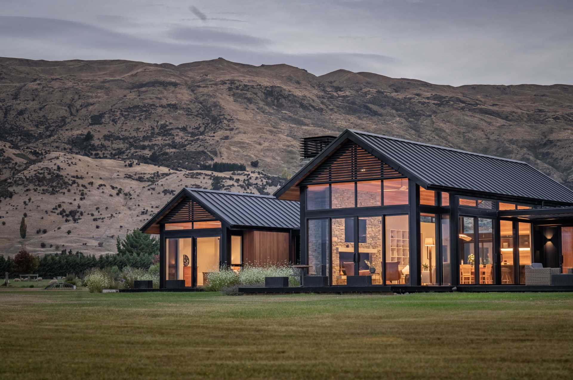 This modern house uses cedar in the build to add warmth, while metal was chosen as a low-maintenance contrasting material, and stone accents were added using Schist.