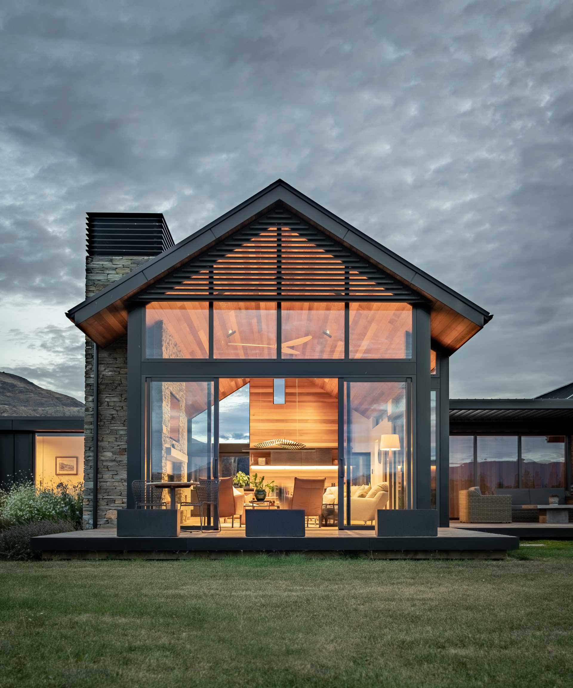 This modern house uses cedar in the build to add warmth, while metal was chosen as a low-maintenance contrasting material, and stone accents were added using Schist.