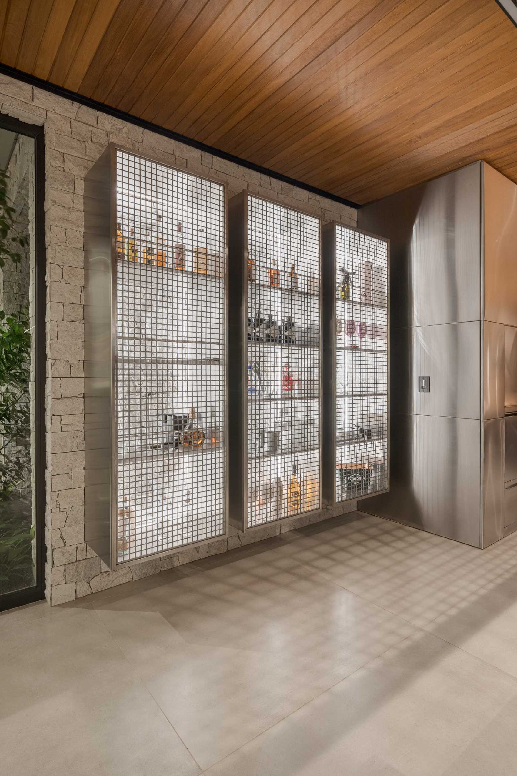 Metal cabinets with cage-like doors are used for storing a variety of drinks.