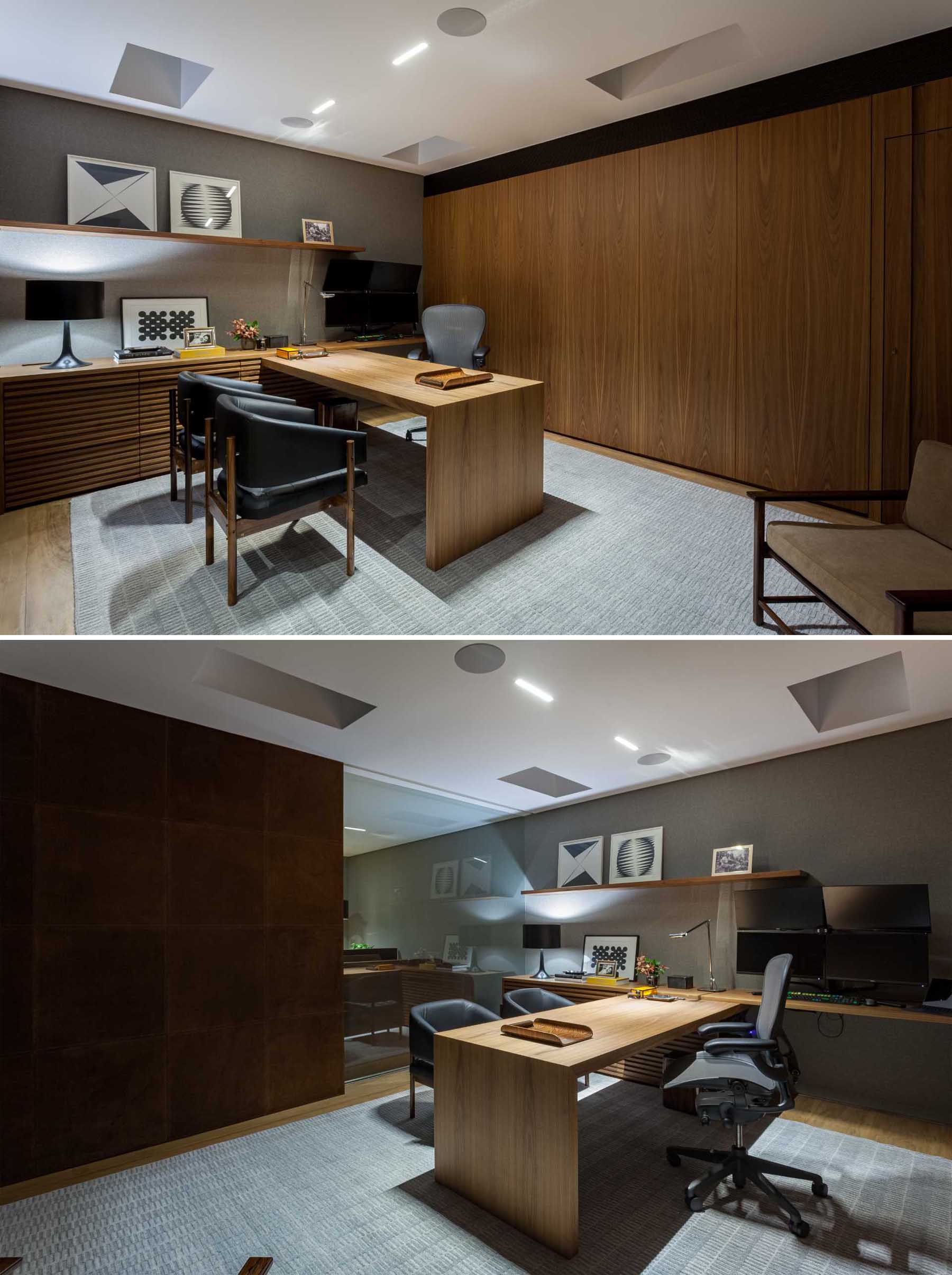 This modern home office includes a floating shelf for displaying artwork, a grey accent wall, and wood furniture.