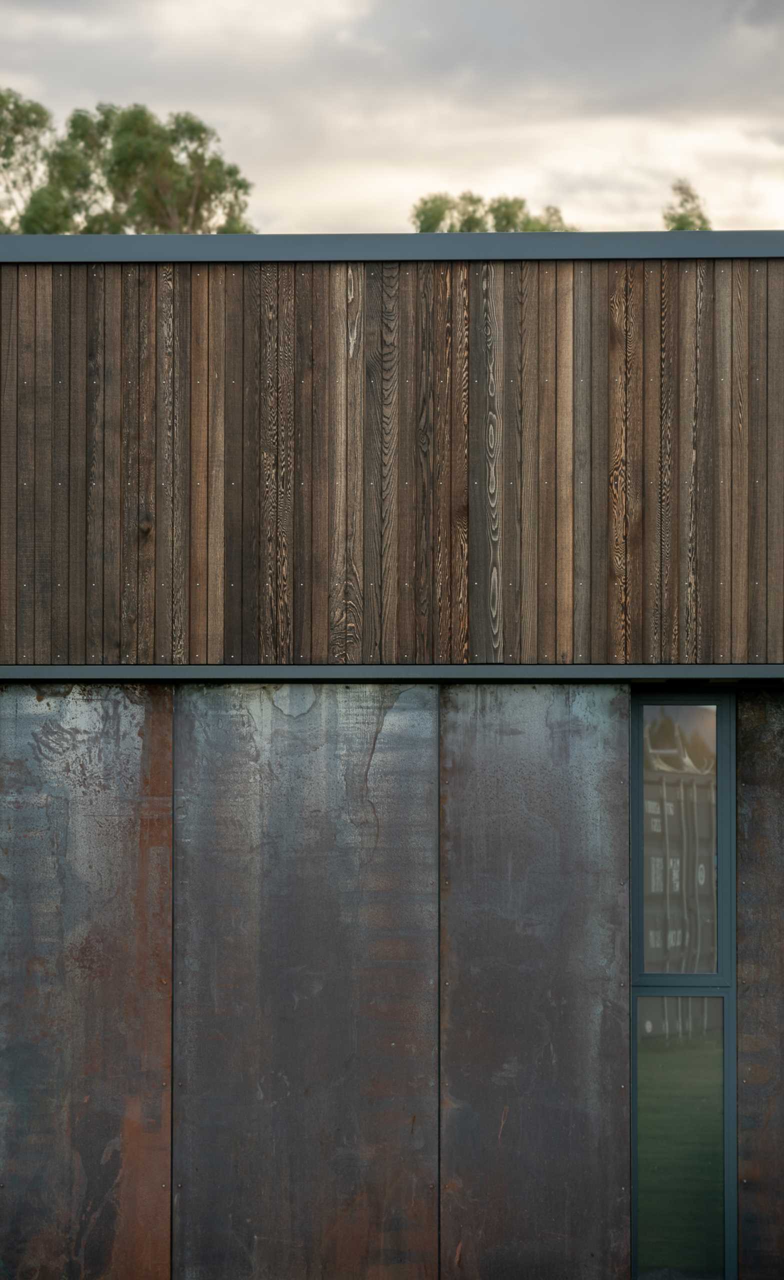 A modern house with wood and steel siding.