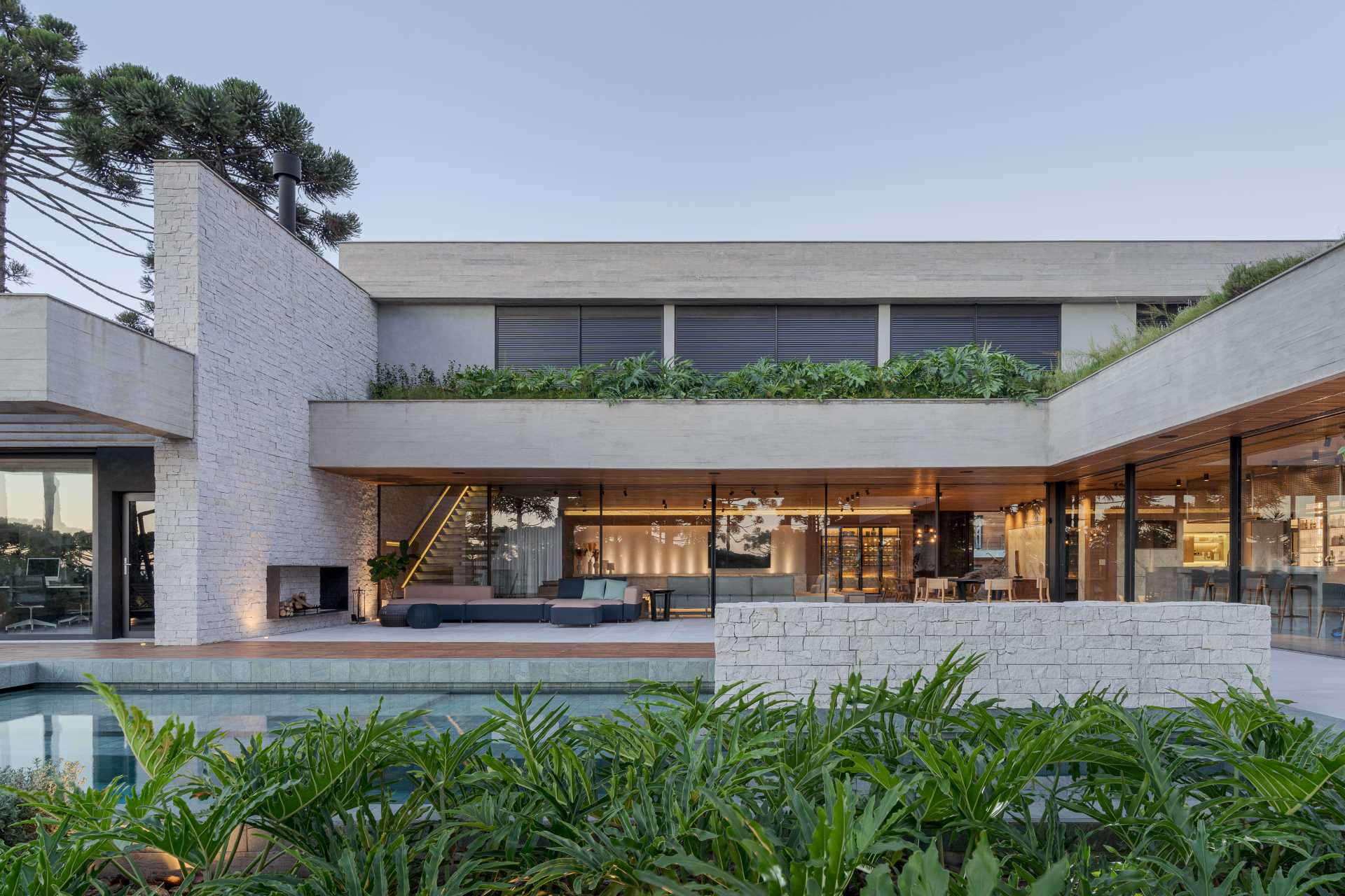 Architecture firm StudioColnaghi has designed a modern home in Brazil, that features a material palette of concrete, wood, and natural stone.