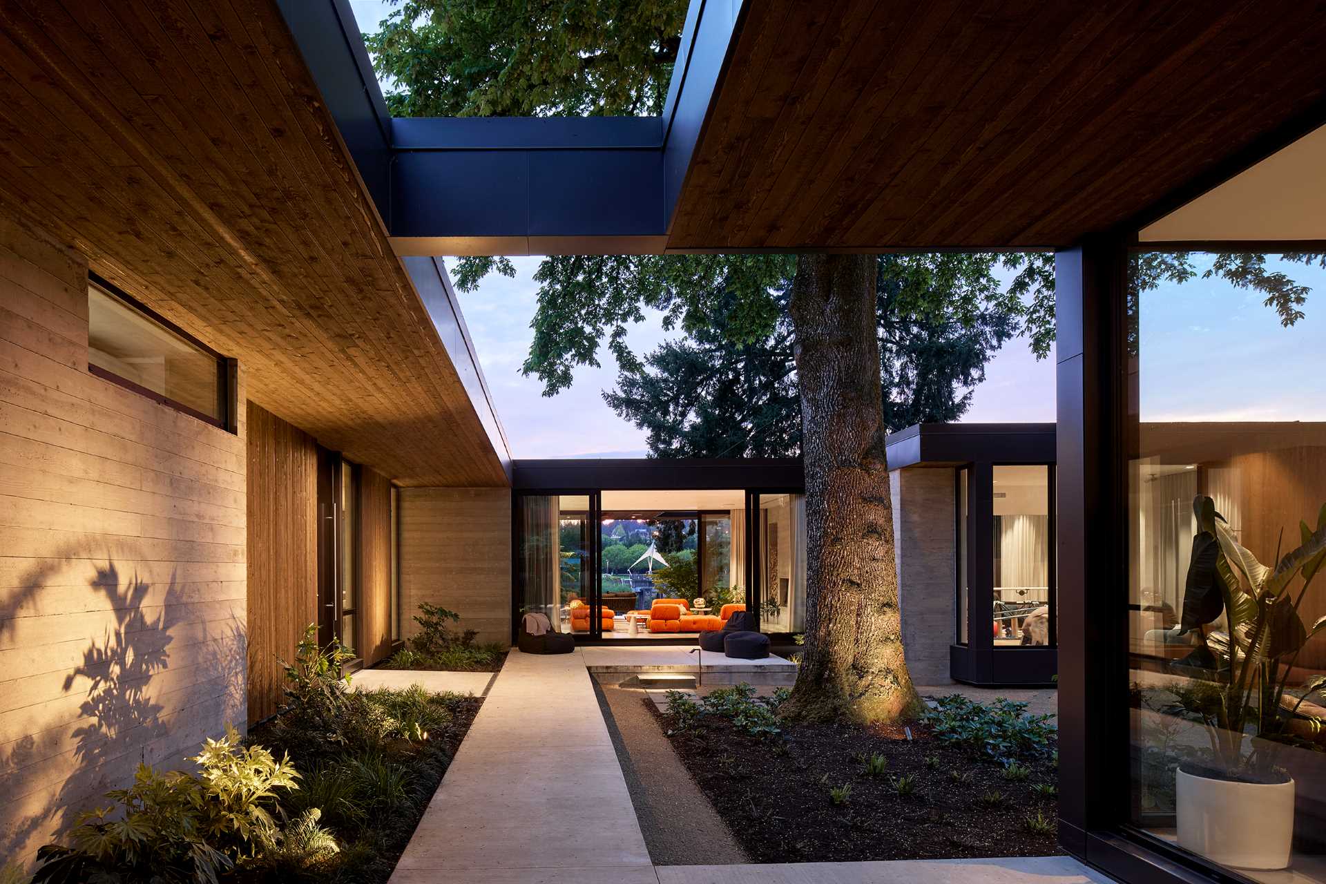 Materials like cedar, aluminum, and board-formed concrete are featured in the home's exterior materials.