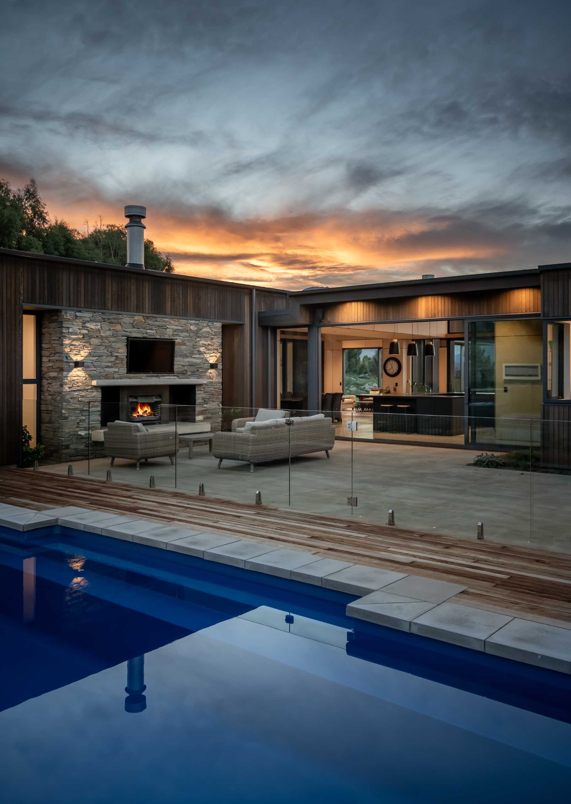 A modern house with a sheltered patio and swimming pool.