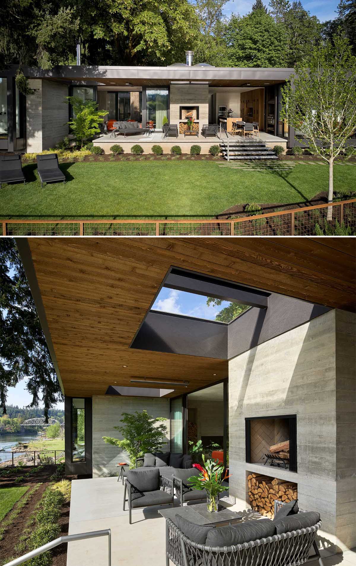 An outdoor living area organized around a large wood-burning fireplace. The partially covered patio also includes a lounge area and a dining area, while steps lead down to the backyard.