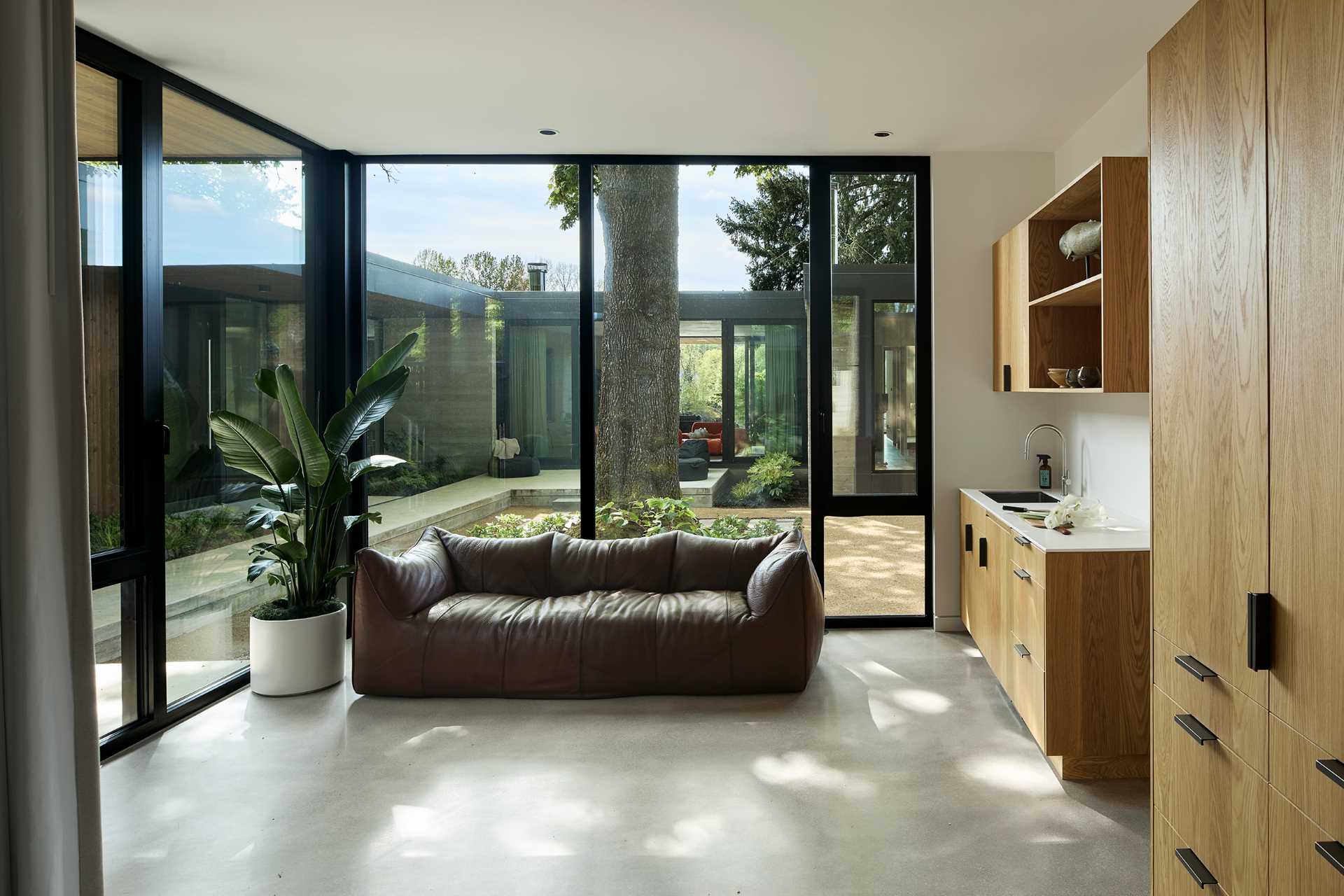 The living room of a guest suite has views of the main house and courtyard.