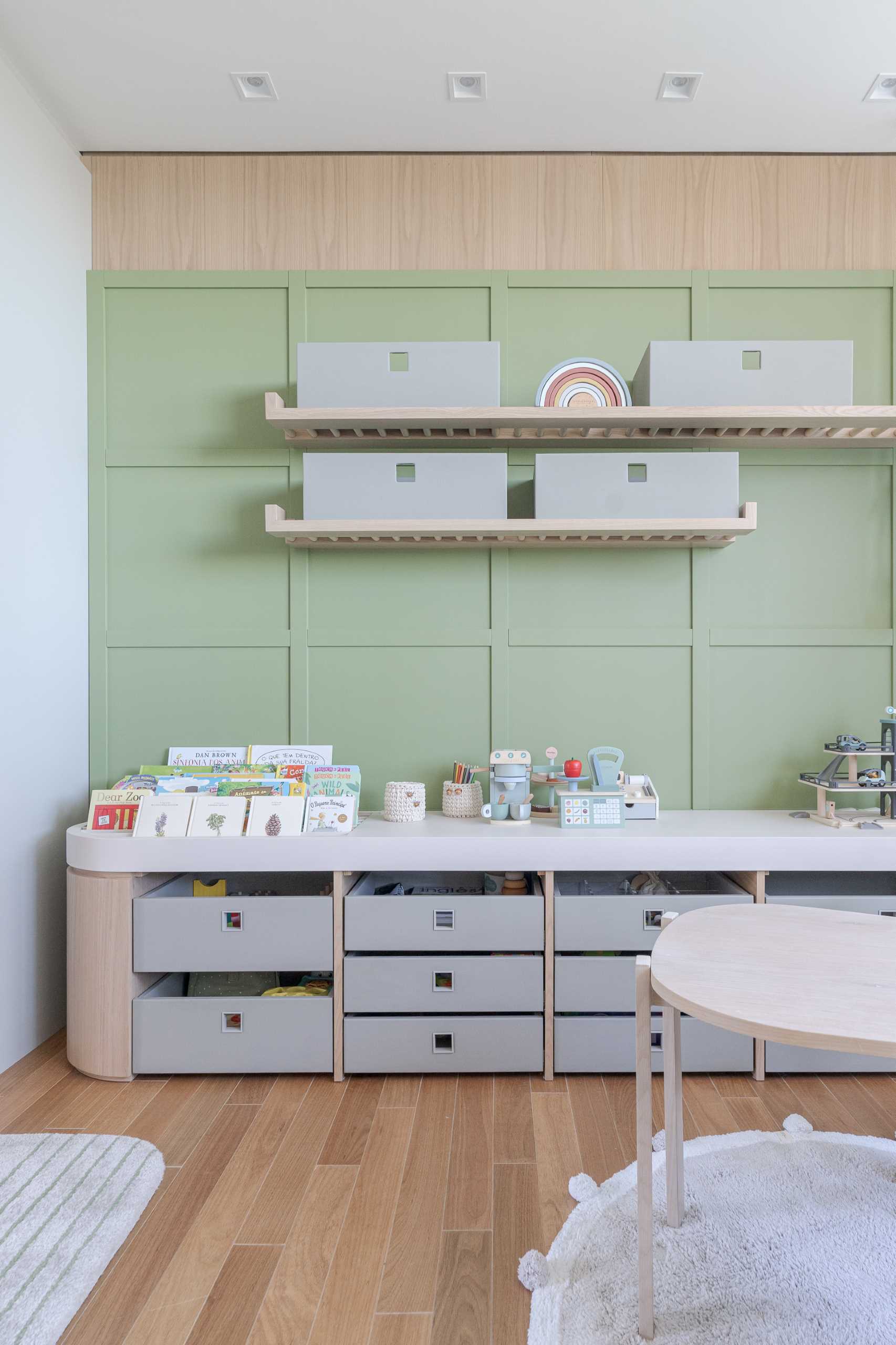 A modern kids room with plenty of storage for toys.