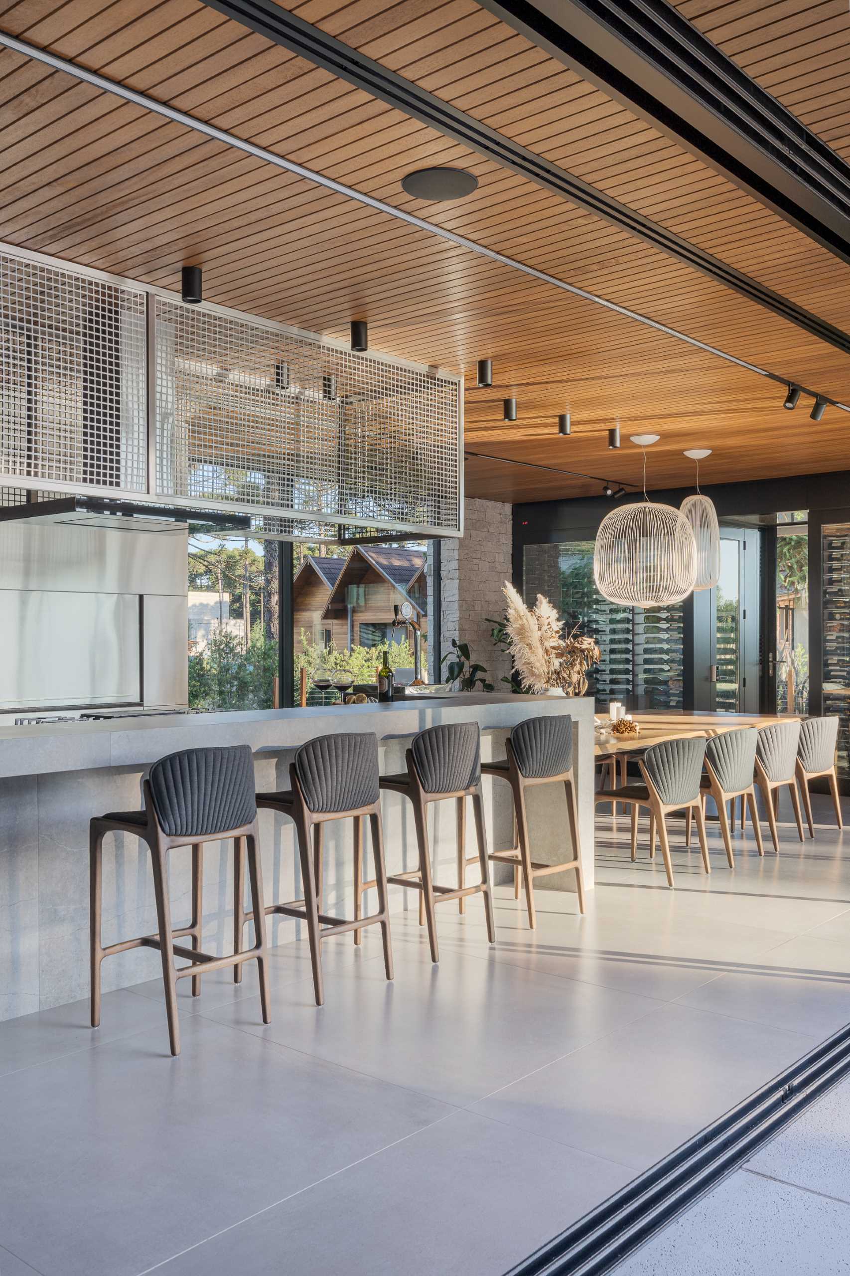 A modern kitchen with a long island that transitions into a dining table.