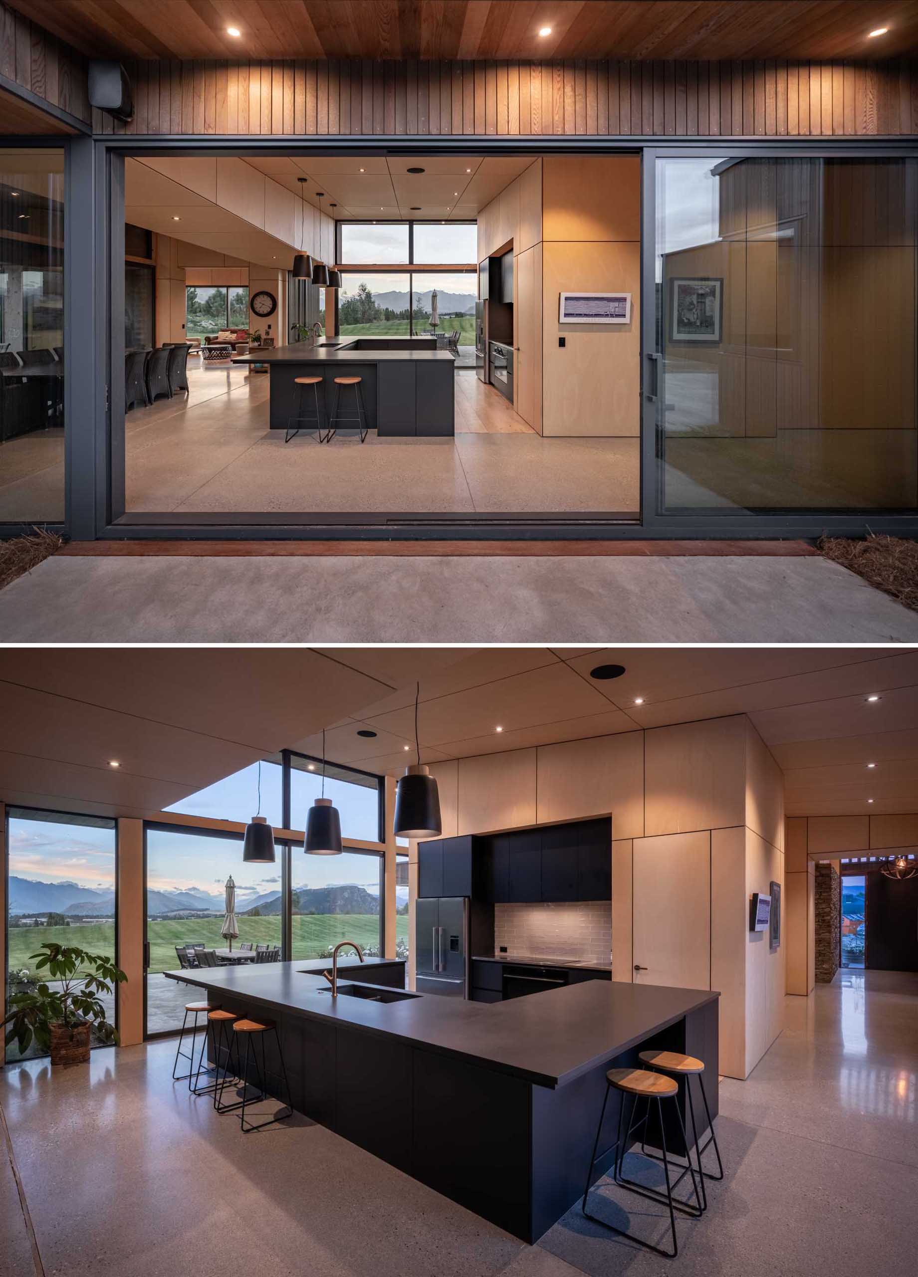 Inside this modern house, there's an expansive U-shaped kitchen island that provides plenty of working space for the homeowners to cook and entertain.