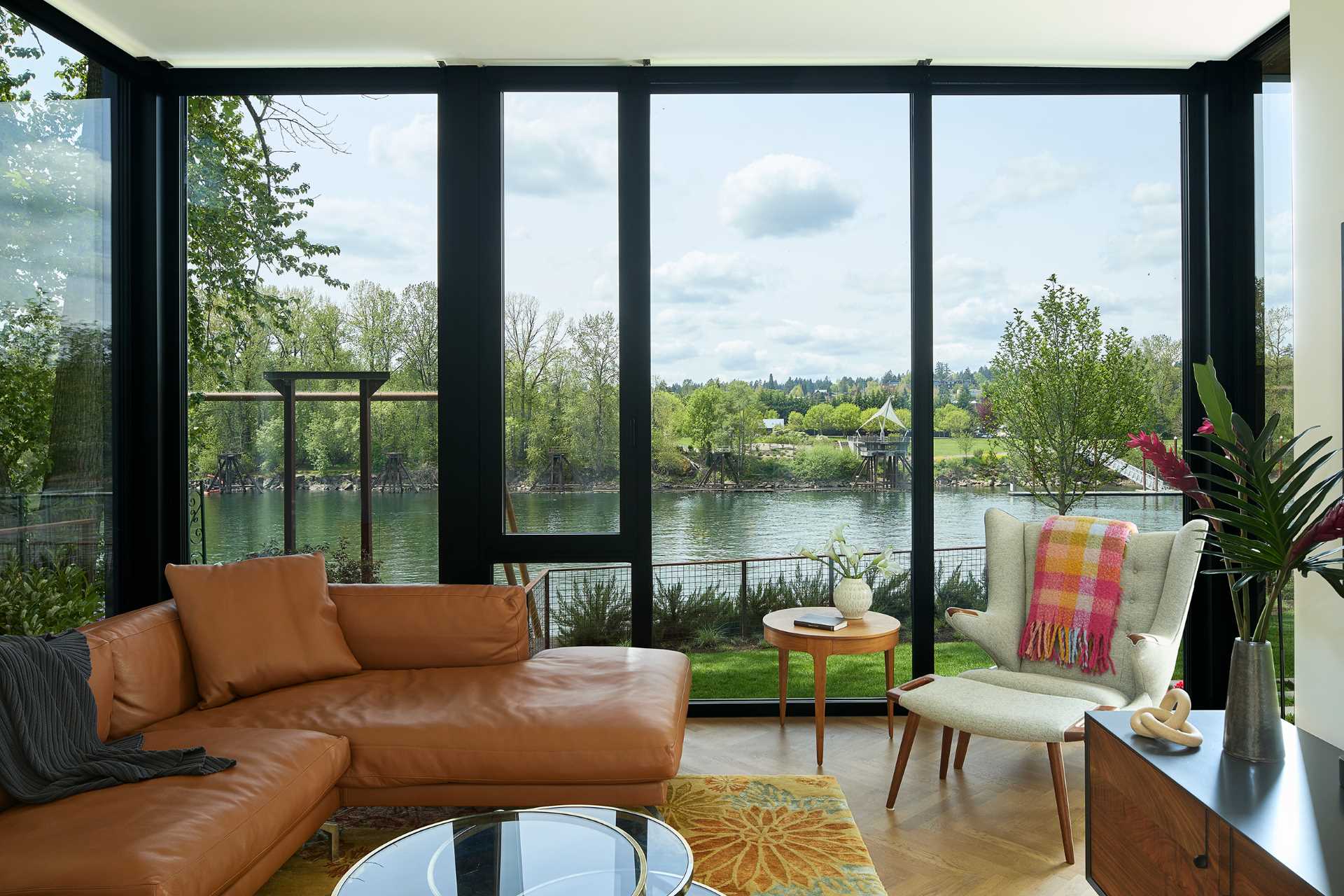 A modern living room with floor-to-ceiling windows.