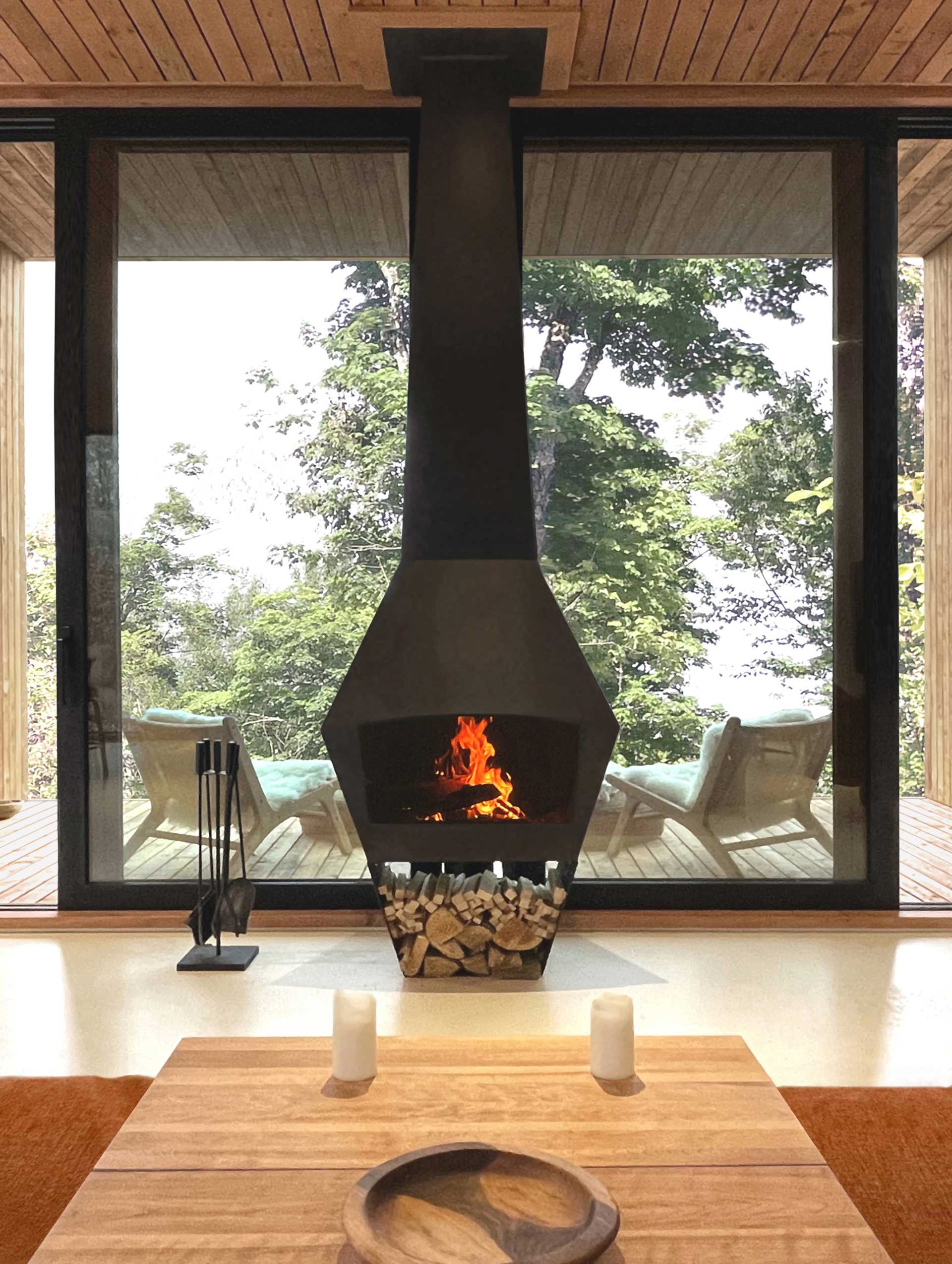 A modern house with a black fireplace in the living room.