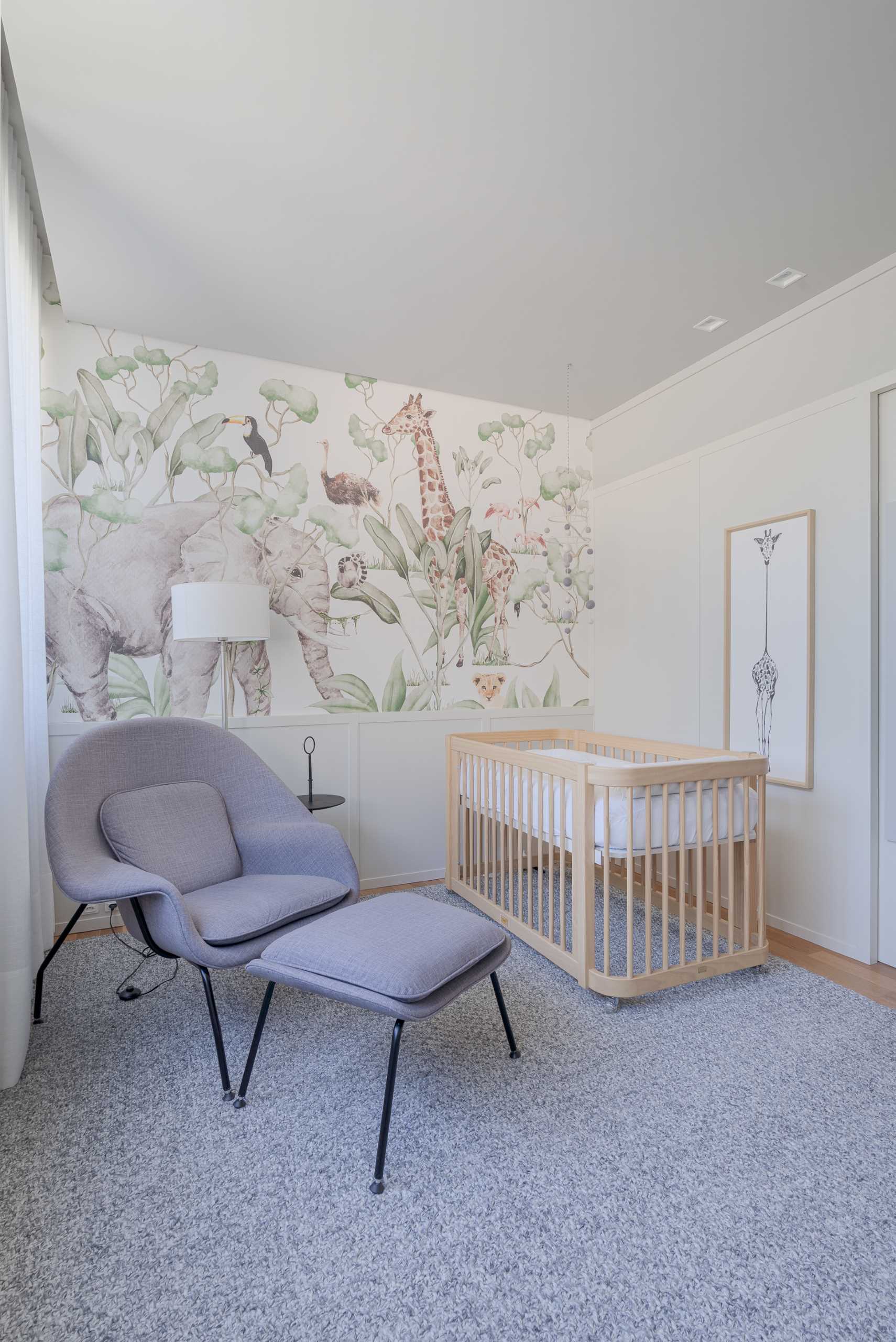 In the nursery, an large grey rug adds a soft element, while the wall showcases an animal mural.