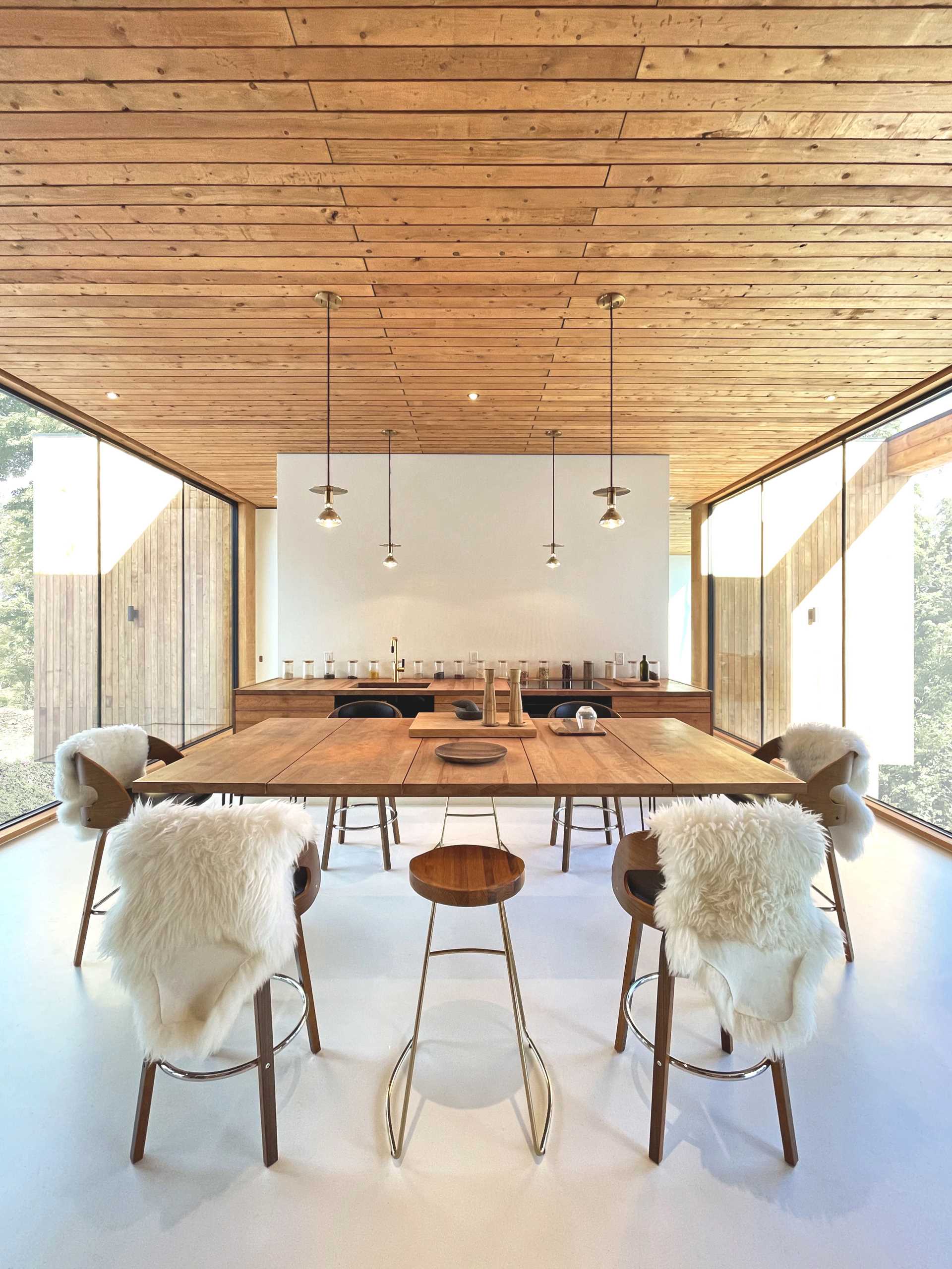 This dining area separates the living room from the kitchen, where the lower cabinets line the wall.