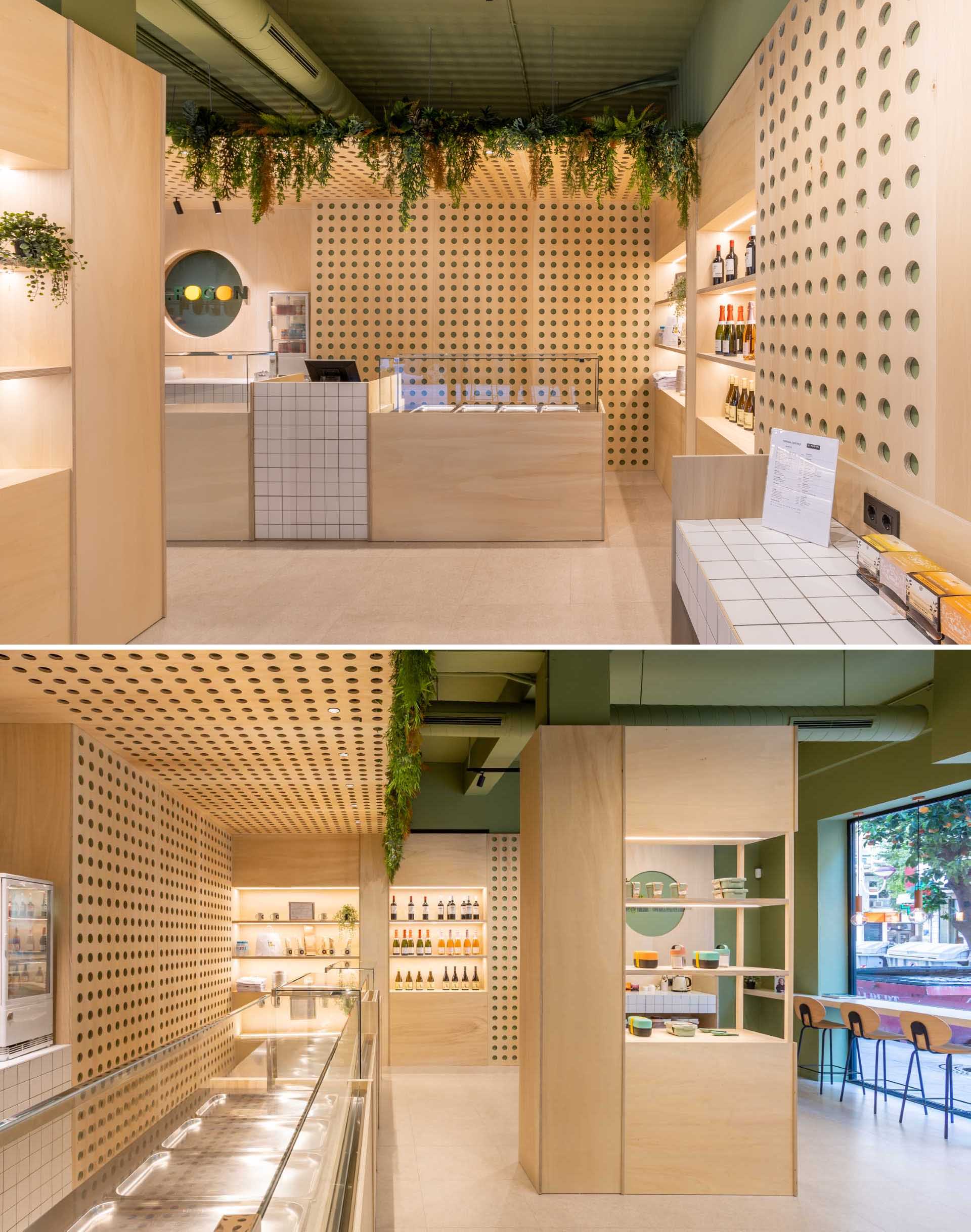 A modern takeaway shop with perforated wood panels, plants, and shelving with LED lighting.