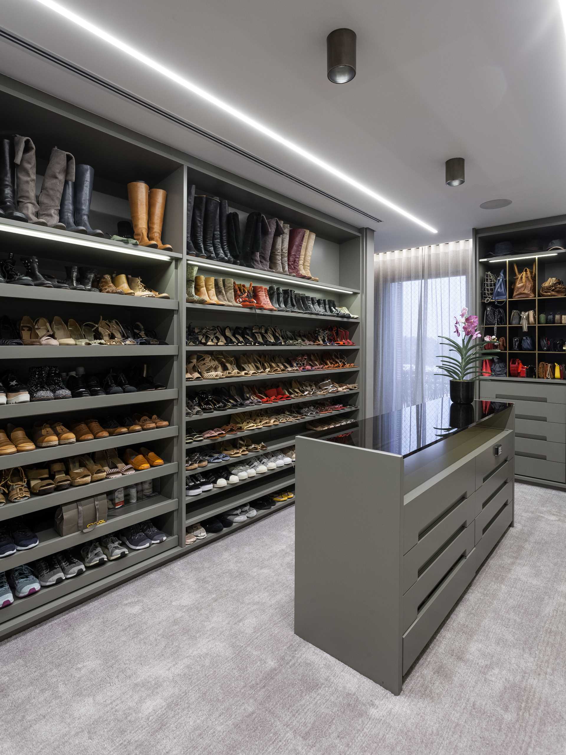 A walk-in closet with floor-to-ceiling shoe storage, 