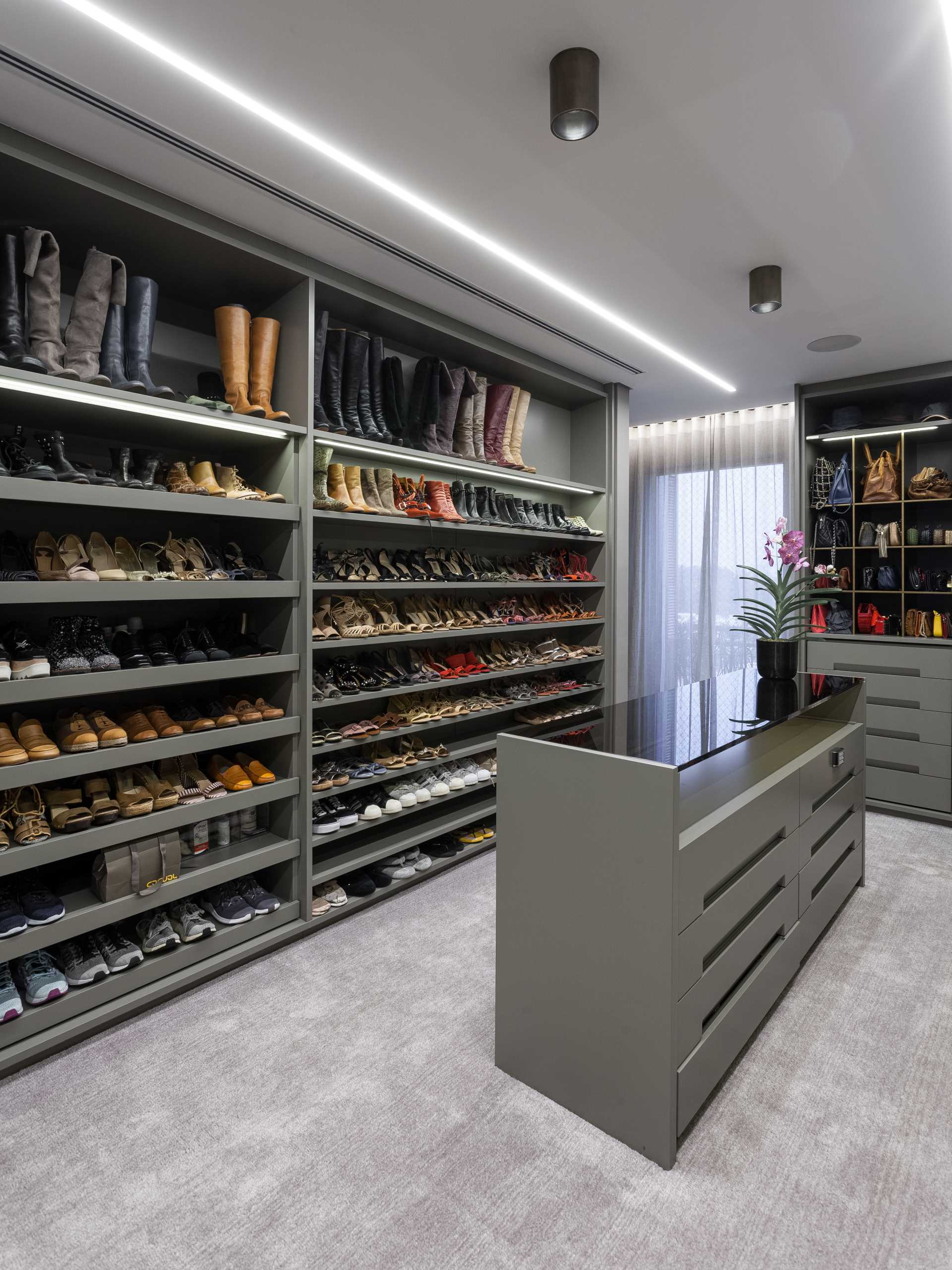 A walk-in closet with floor-to-ceiling shoe storage,
