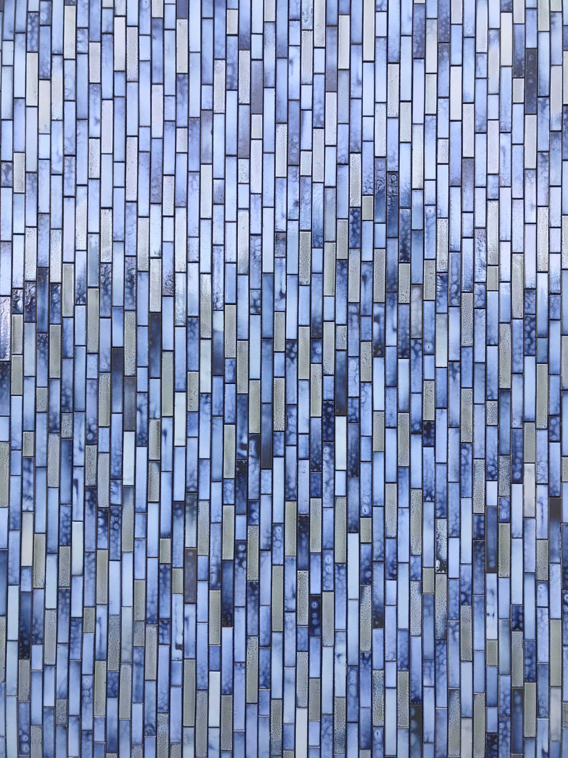 A modern house covered in blue tiles.