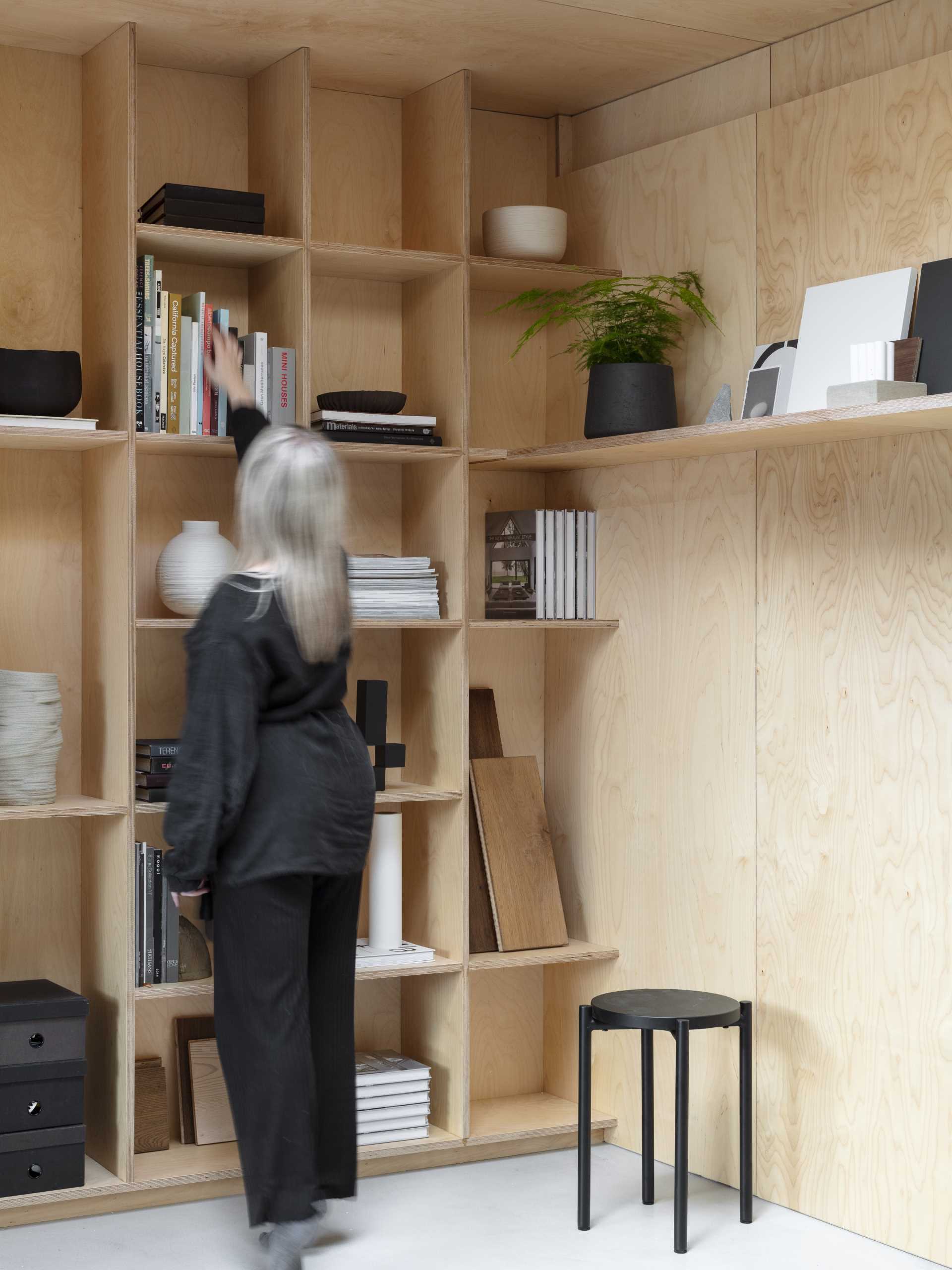 A wall of plywood bookshelves.