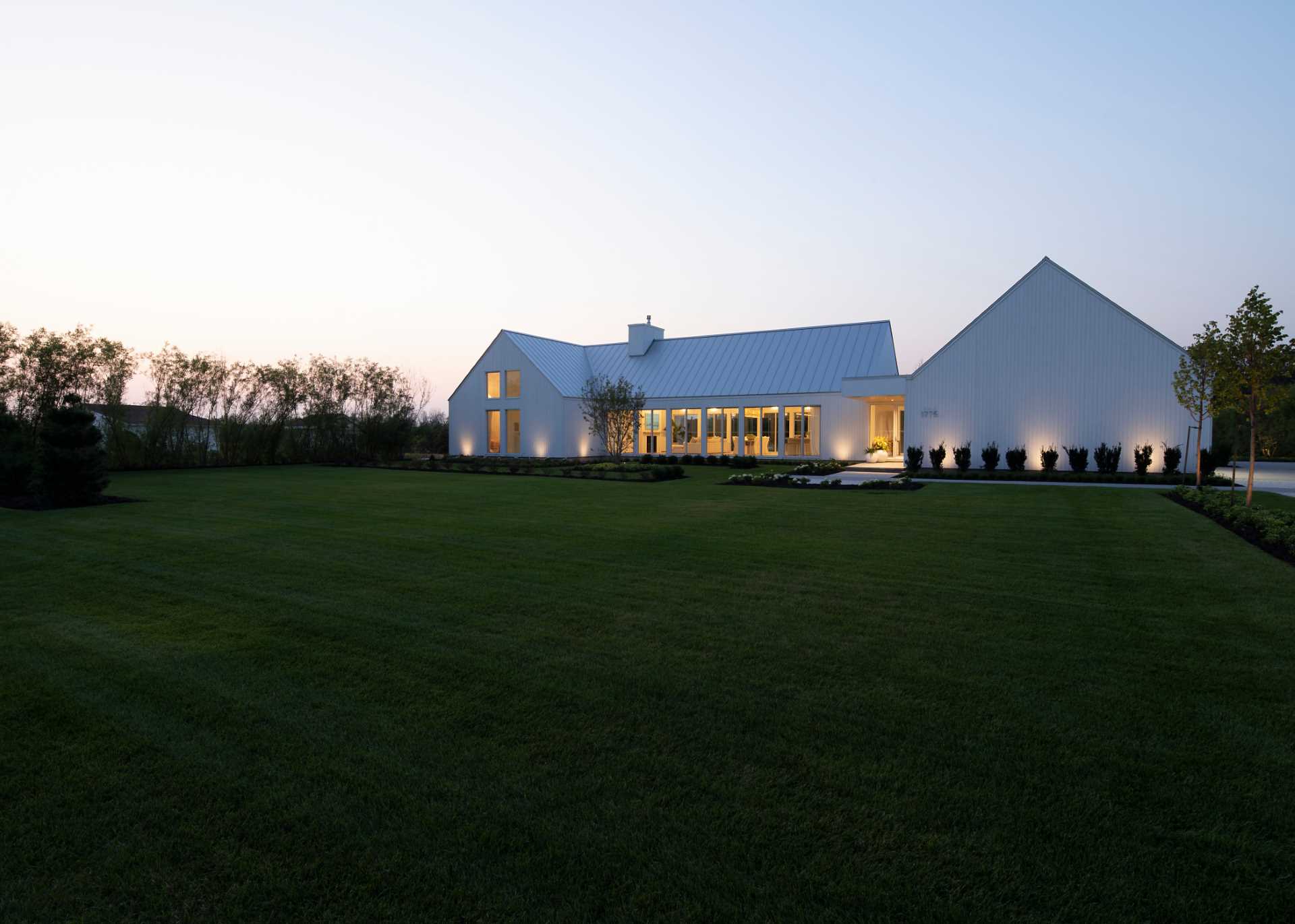 A contemporary house with lighting that highlights the exterior.