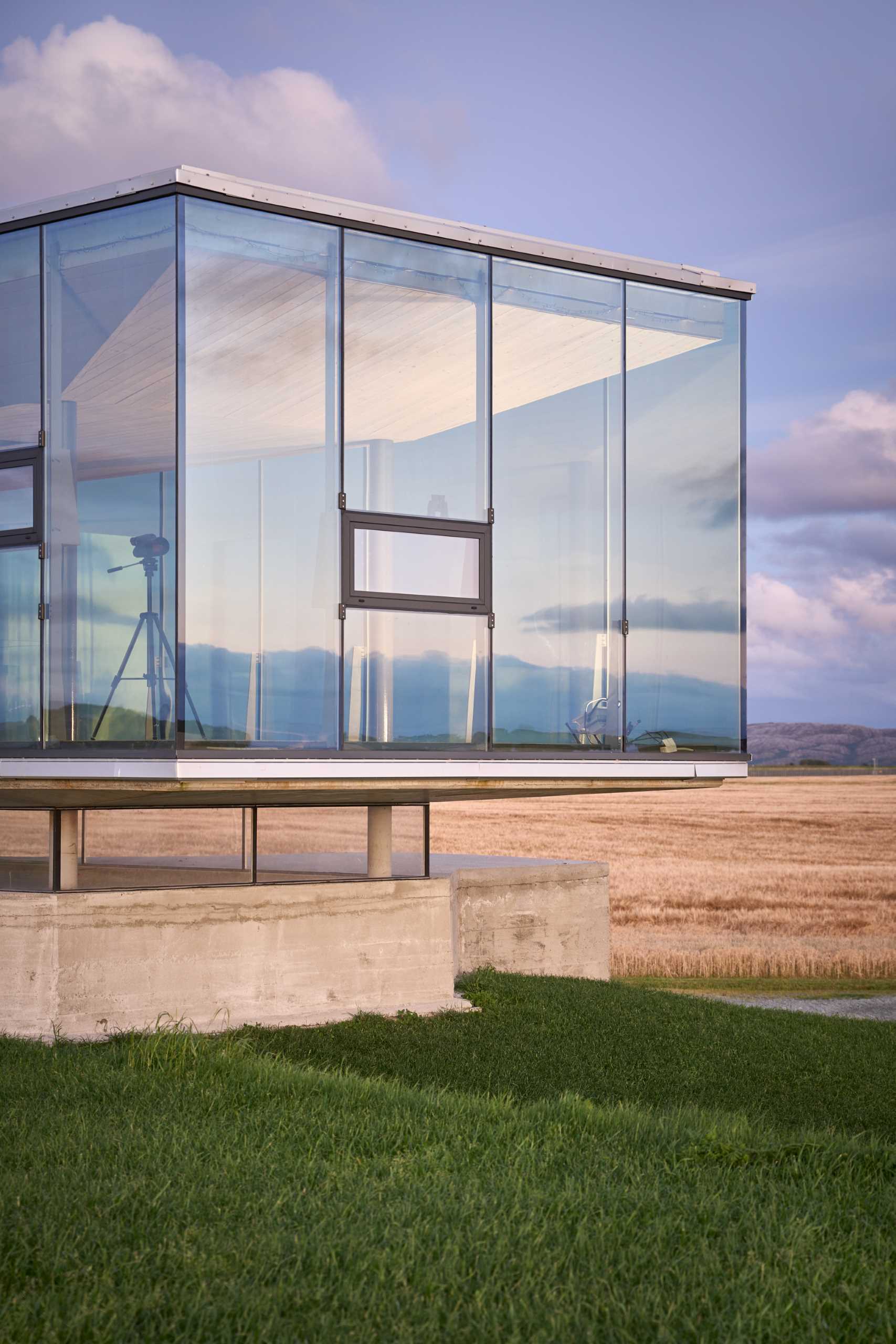 An old military bunker has been transformed into an event space with a glass-enclosed box.