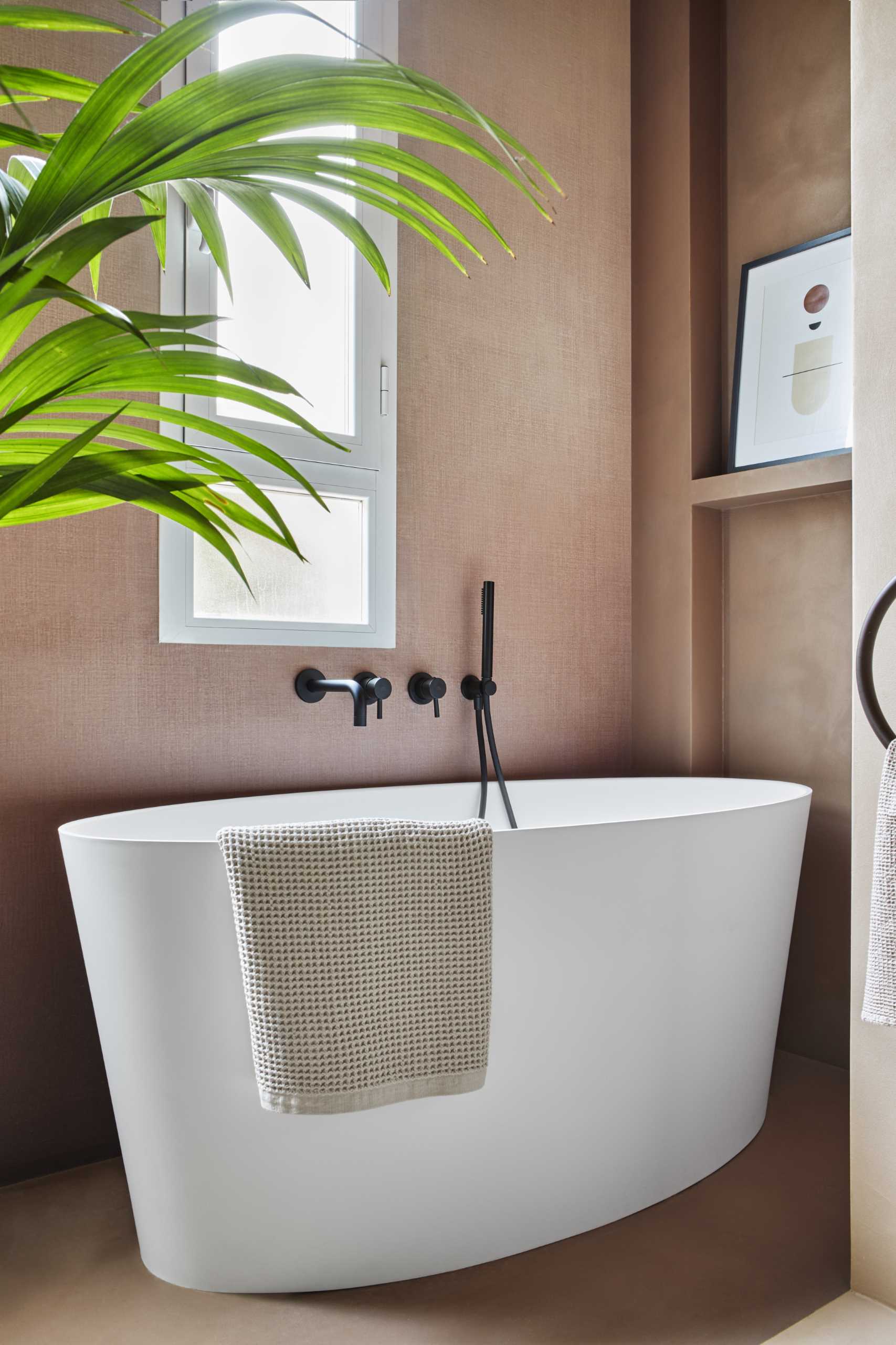 A modern bathroom with a freestanding bathtub.